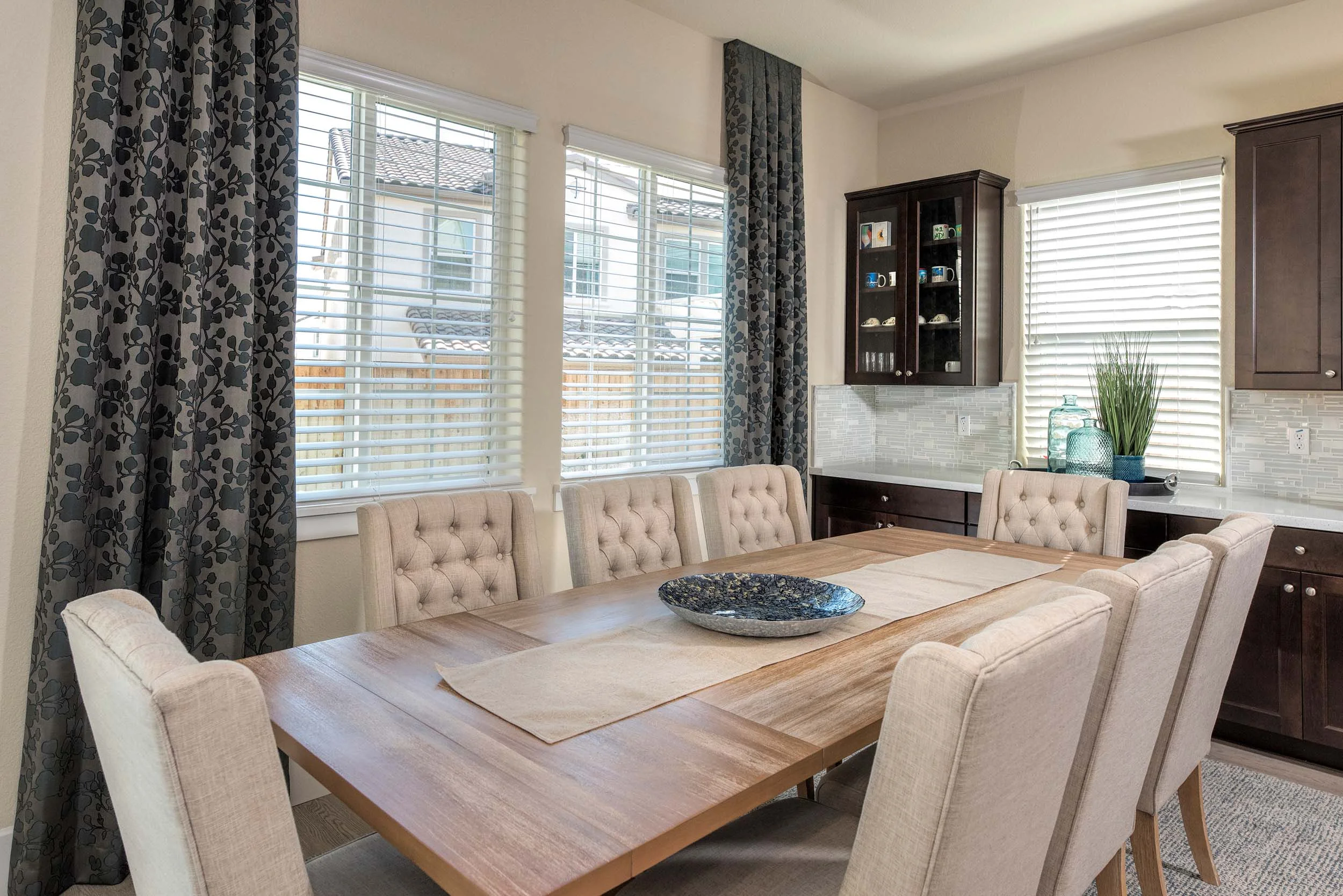 Dining table with chairs, large window, wooden table and wooden cabinet