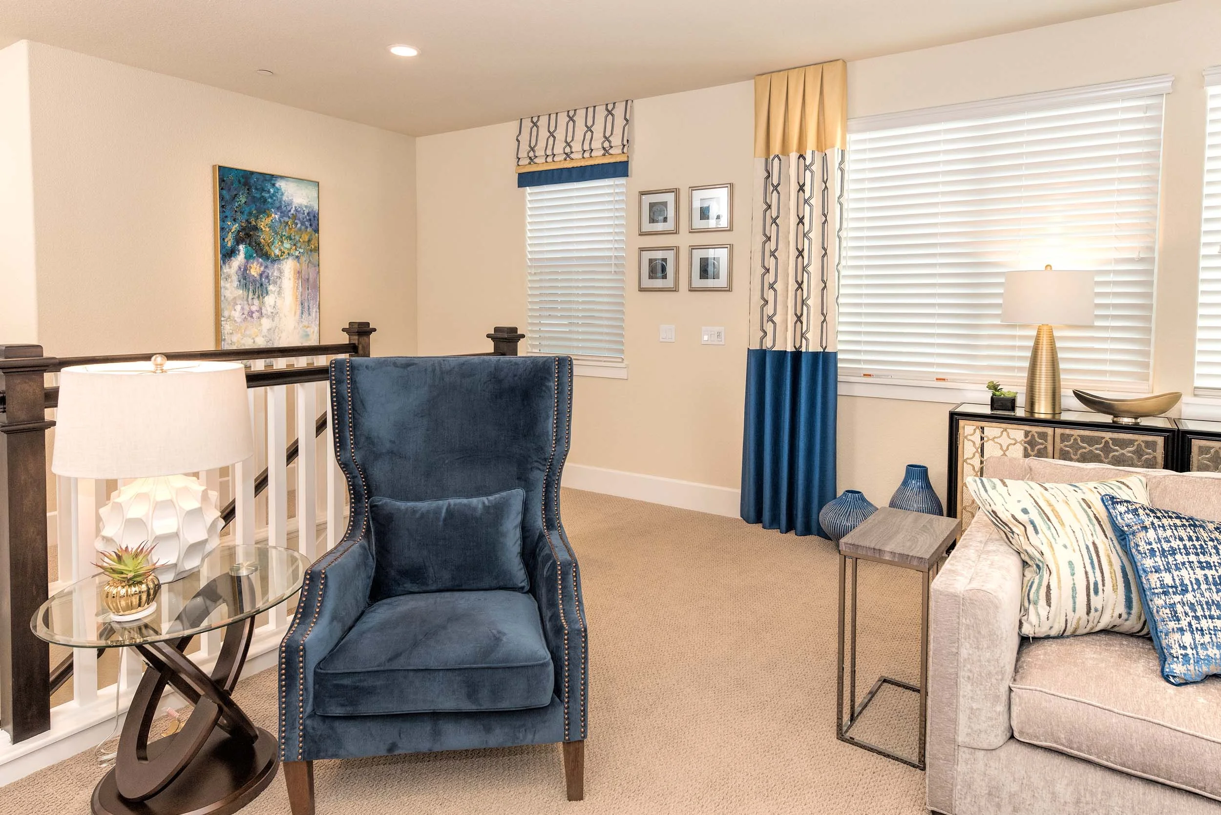House interior with sofa, window, table lamps and artwork on wall