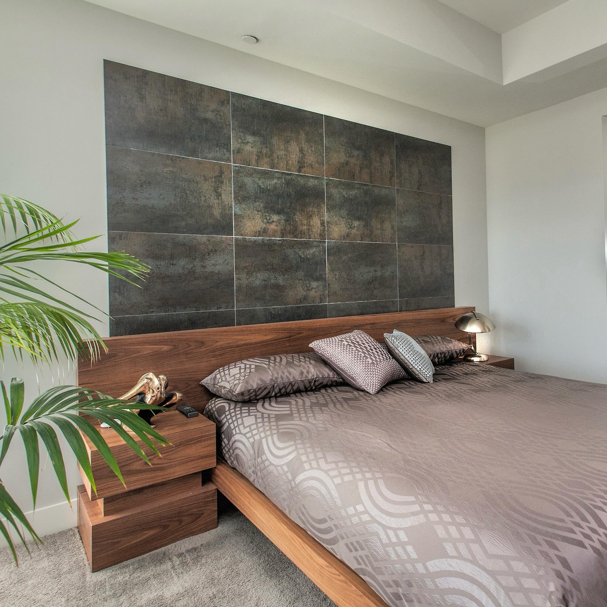 Nothing commands attention in a room like a tiled accent wall acting like an extension of the headboard. It acts as a focal point while everything else complements the look of the space.