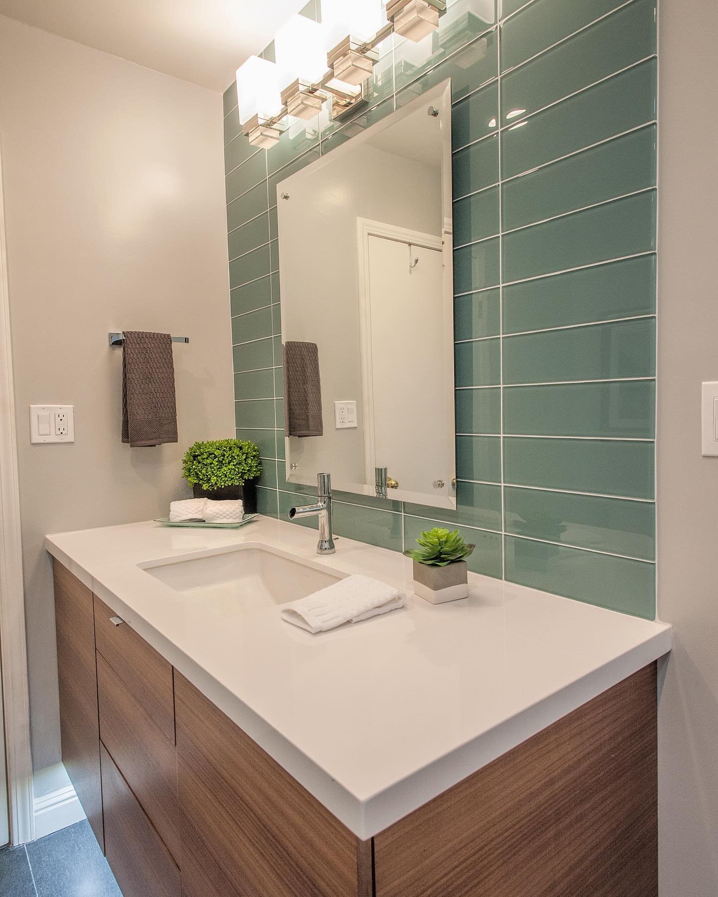 We love how this accent tile adds personality and some reflective dimension to the space!