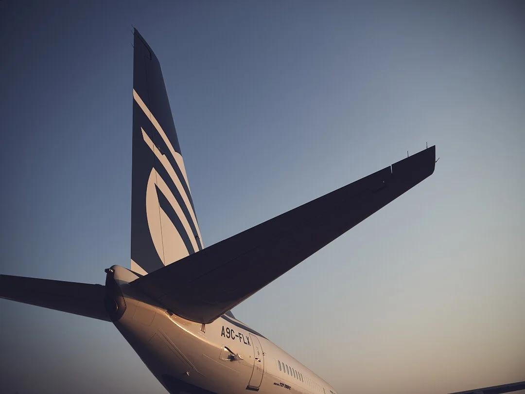 Cargo aircraft wing and tail against the sky