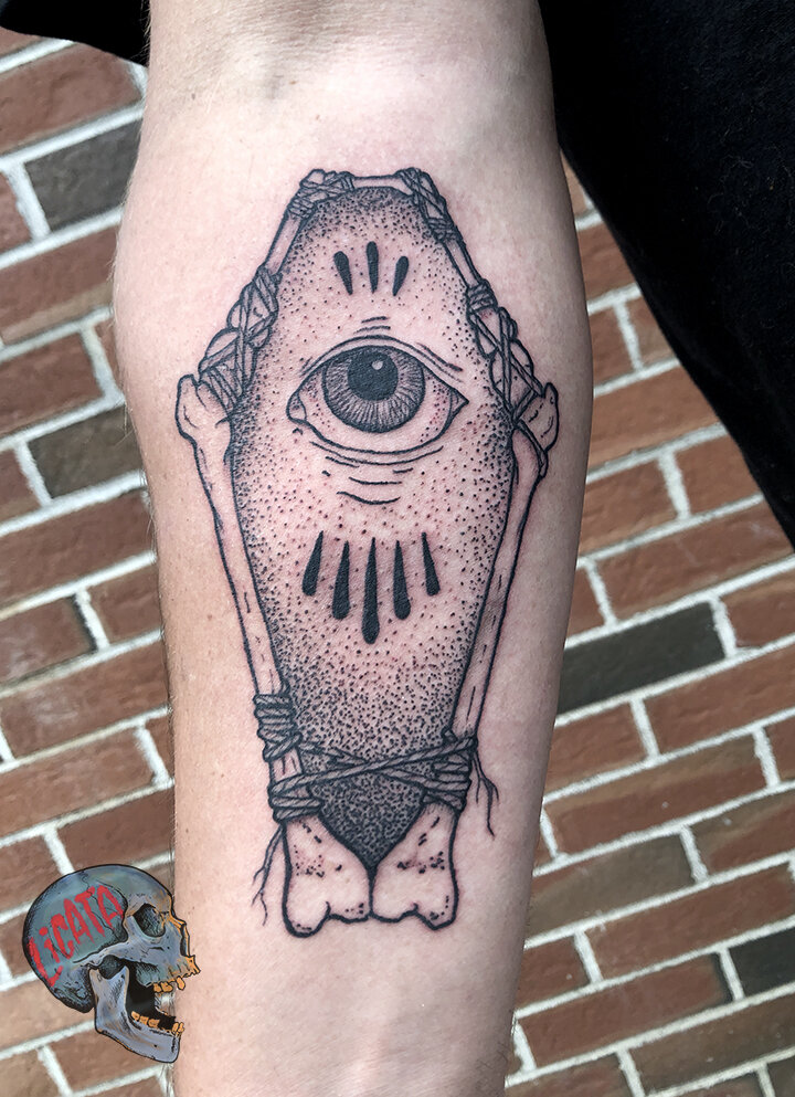 bone coffin eye tattoo