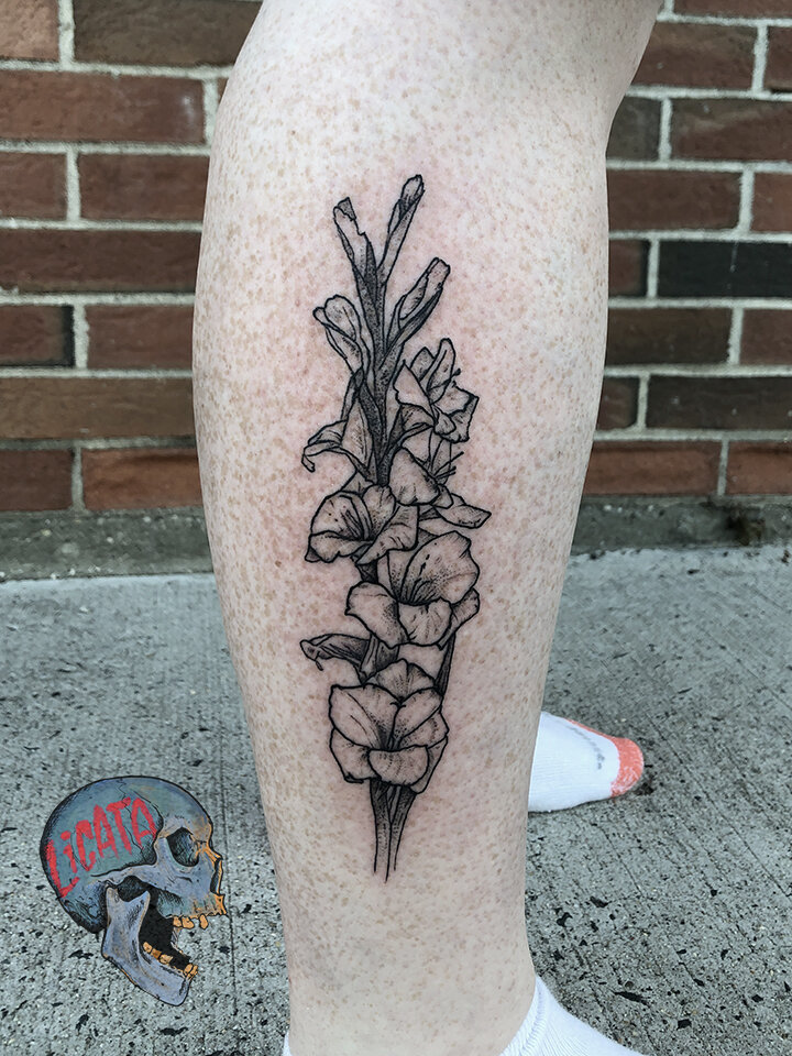 illustrative flower tattoo on calf