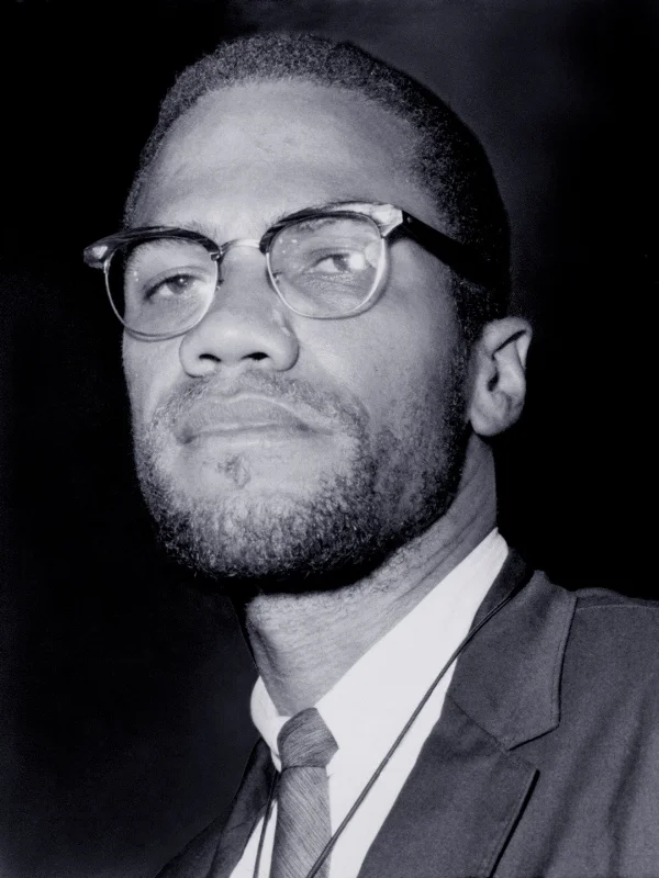Malcolm X wearing Club Masters glasses.
