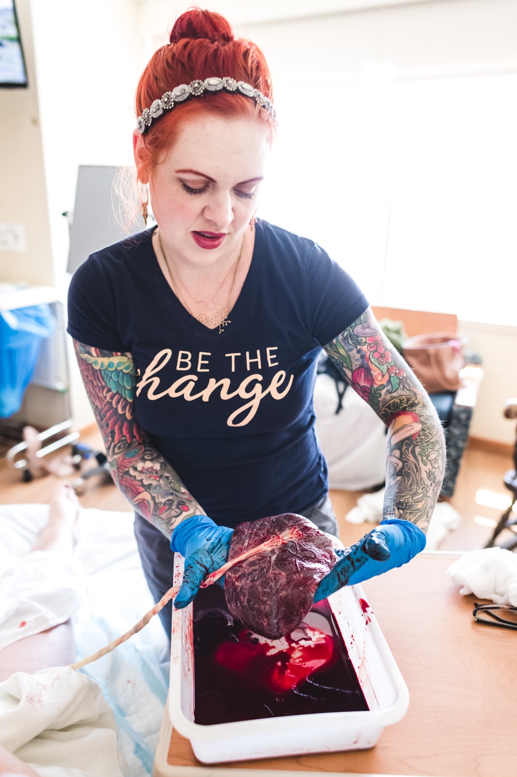 Amy showing her client their placenta at a birth