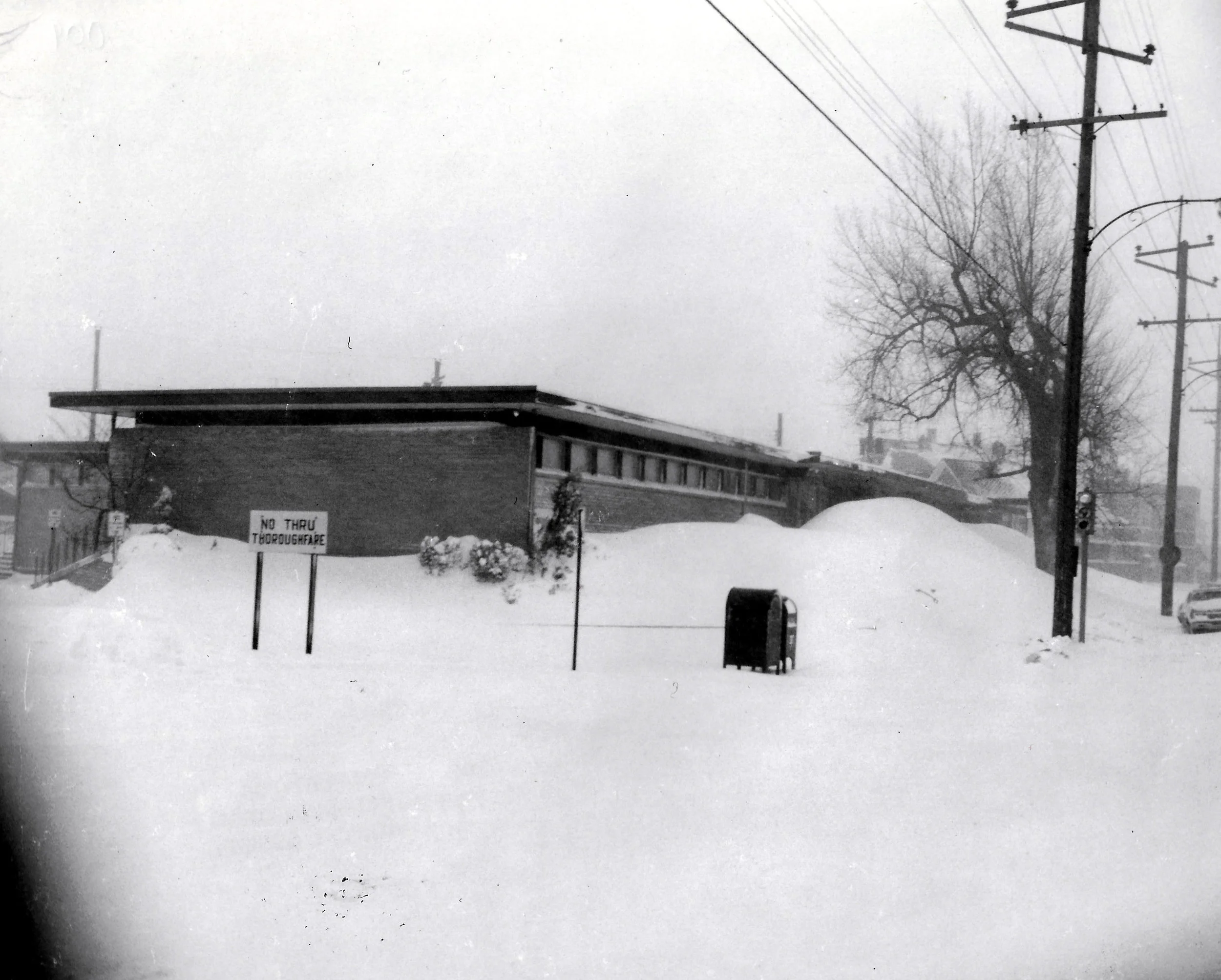 Snow drifts piled up nearly to the roof of the Whiting Clinic on Indianapolis Boulevard, which Dr. Donald H. Rudser kept open to deal with any local emergencies during and after the blizzard.
