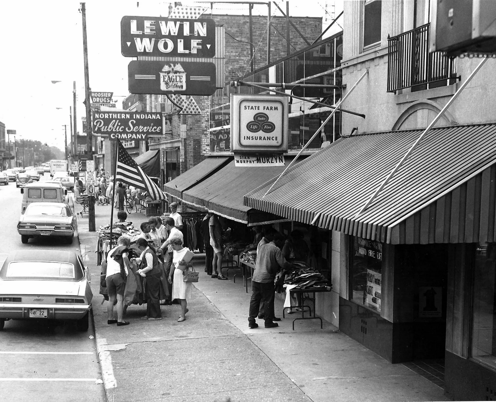 Shoppers are out for “Frontier Days,” a downtown shopping promotion, in 1969. Looking west on 119th Street, the State Farm Insurance office is at 1319 119th Street, with Lewin-Wolf clothing store at 1315, and the NIPSCO office at 1311. (Lovasko Studio photograph)