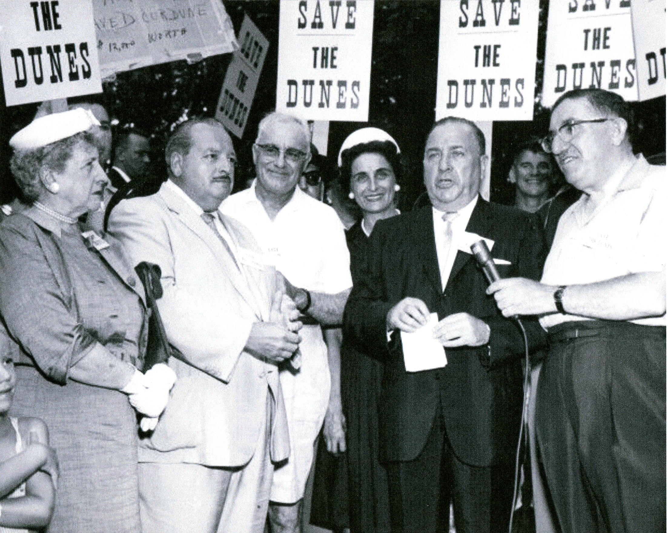 There was a major push over the years to level the Indiana Dunes and convert the land to industrial use. Thousands of citizens spoke up and fought the effort, which was led politically by Illinois U.S. Senator Paul Douglas. The mayors along Lake Michigan also supported the Save the Dunes campaign. In this photo, the mayors of Lake County’s major industrial cities joined Chicago Mayor Richard J. Daley in a late 1950s rally to save the dunes. On the right is Gary Mayor George Chacharis, next to him is Chicago Mayor Daley. Whiting Mayor Mary Bercik is in the center, with Hammond Mayor Edward Dowling next to her. East Chicago Mayor Walter Jeorse is next to Dowling. Dorothy Buell, founder of the Save the Dunes group, is on the left. (Photo courtesy Calumet Regional Archives, Indiana University Northwest)