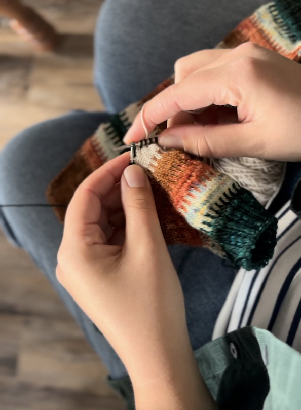 person knitting socks