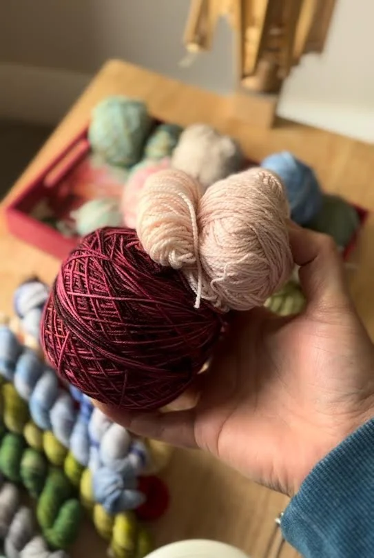 two balls of yarn one light pink and one dark pink