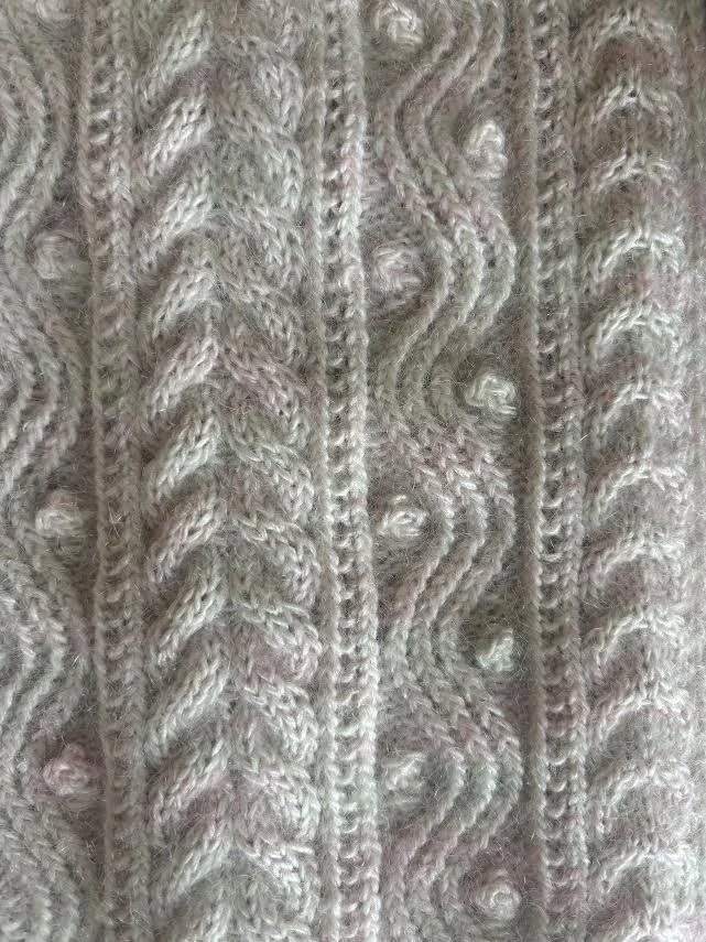 Close up of cables, bobbles, and details of shawl