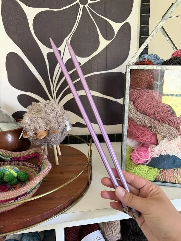 straight knitting needles with colorful background