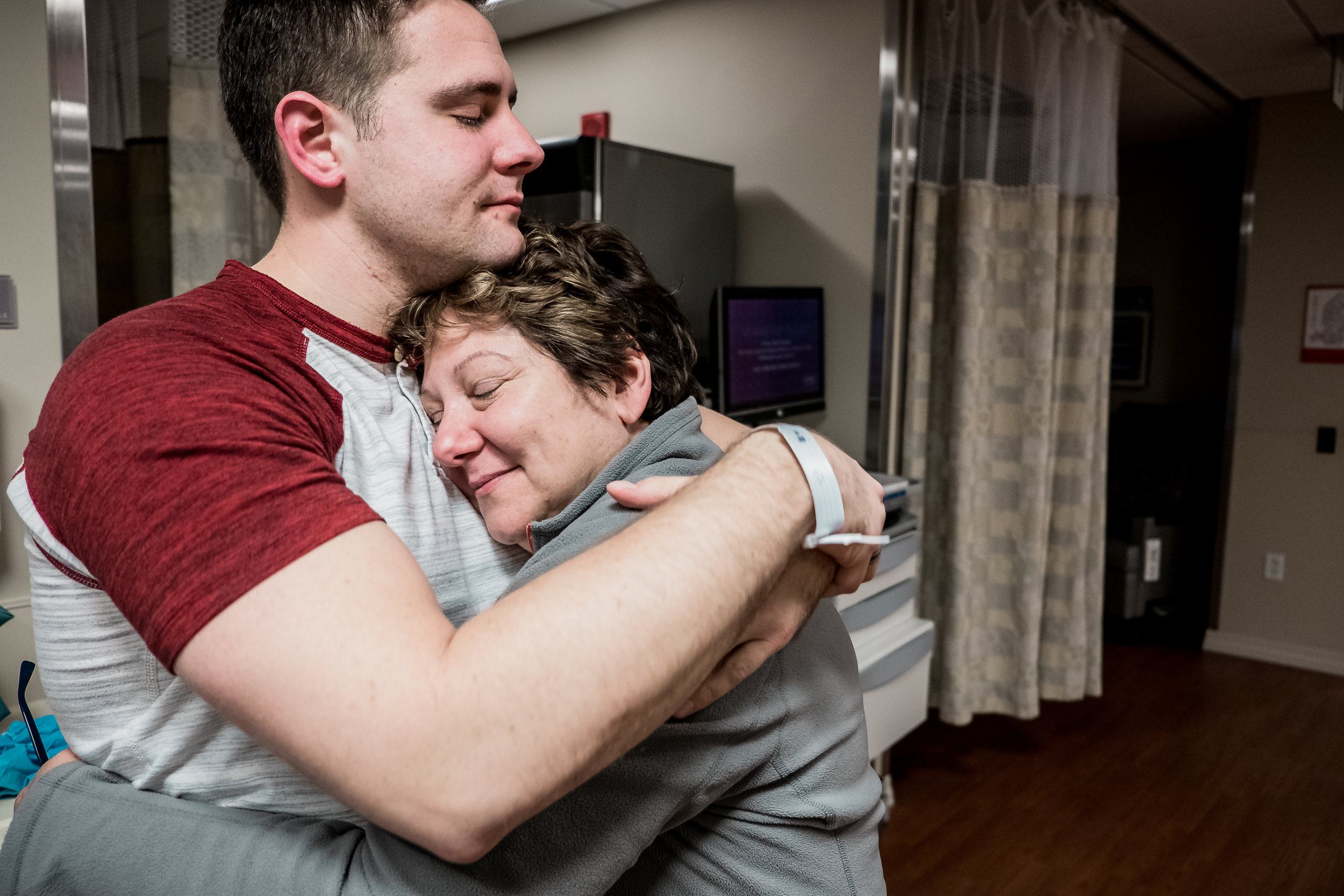 mother and son embracing after birth of baby