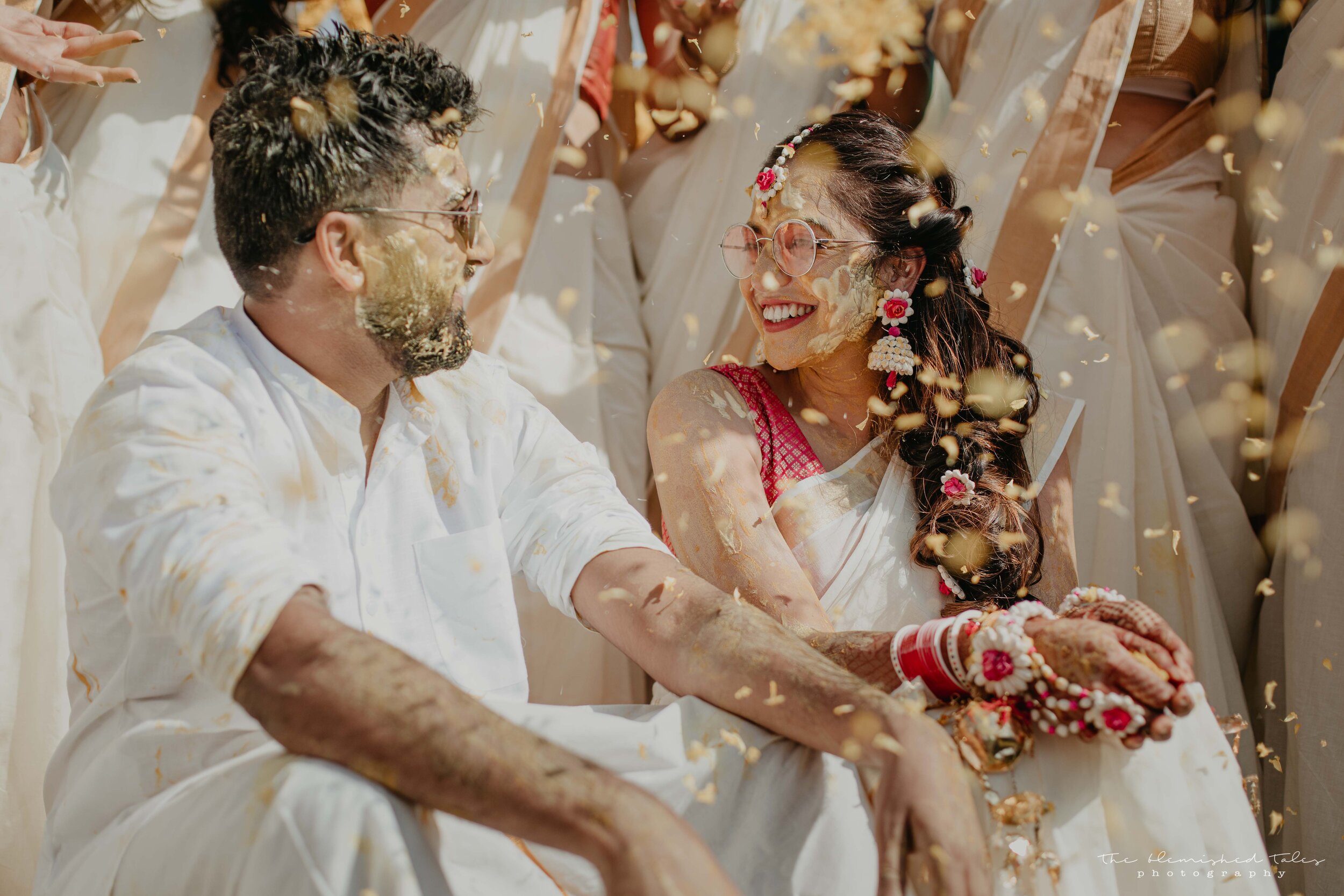 Saloni and Krishnan share a moment as they are showered with flowers just after their haldi