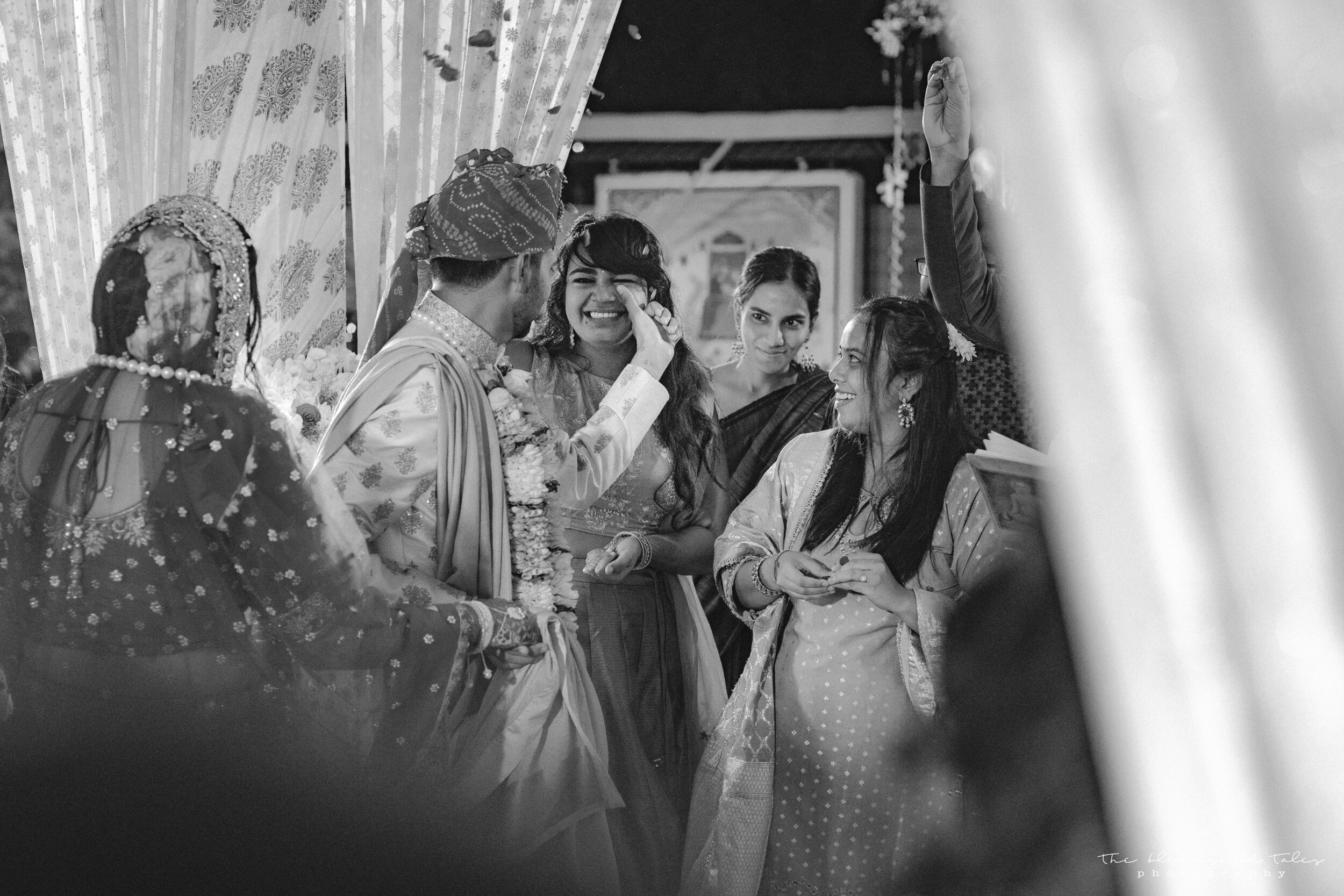 Jai wiping off the happy tears off her sister's cheeks during their Pheras