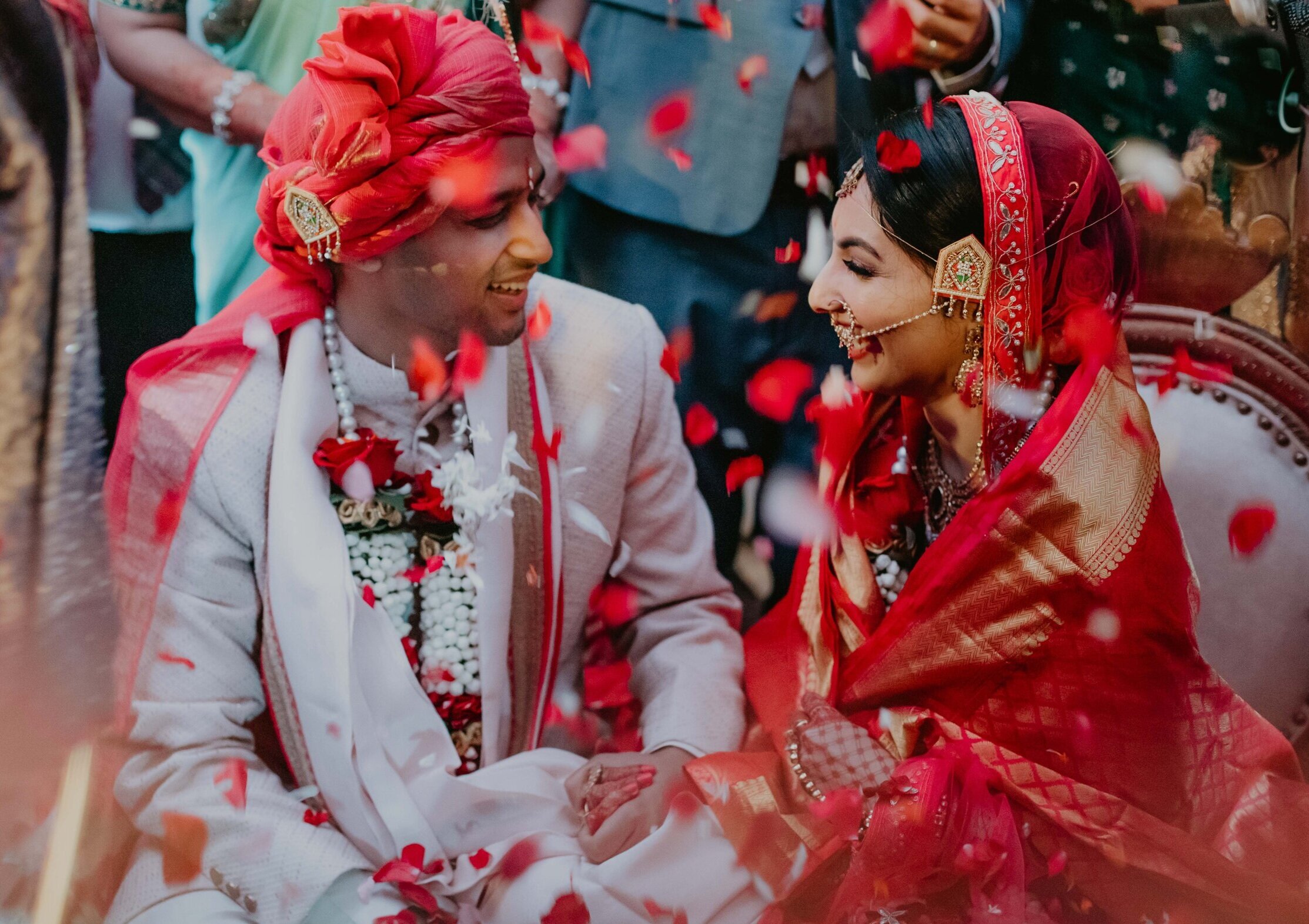 Karishma and Rahul share a moment together just after their wedding as friends and family shower them with roses