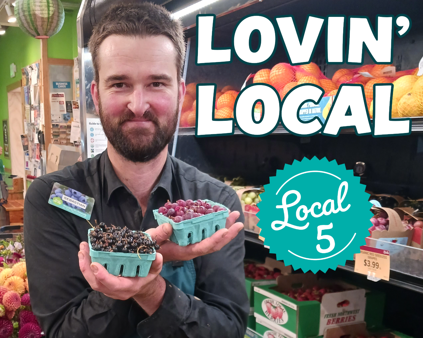 Staff holding local berries in the grocery store