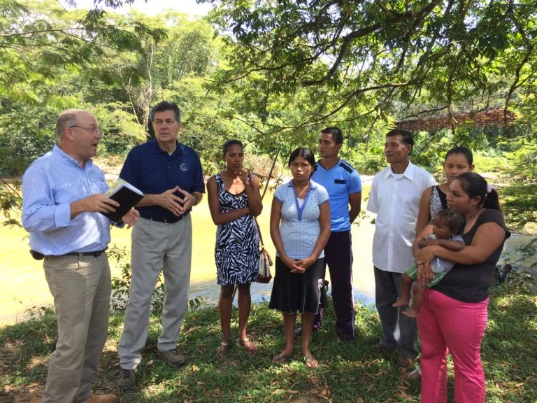 MAG president Sean Donnelly along with MAG missionary, Pastor Carlos Paz, preaching to a crowd at a spontaneous baptismal service.