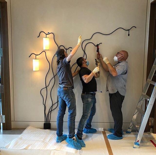 Onsite installation. Putting the finishing touches on a wall mount Royere light fixture. NYC.