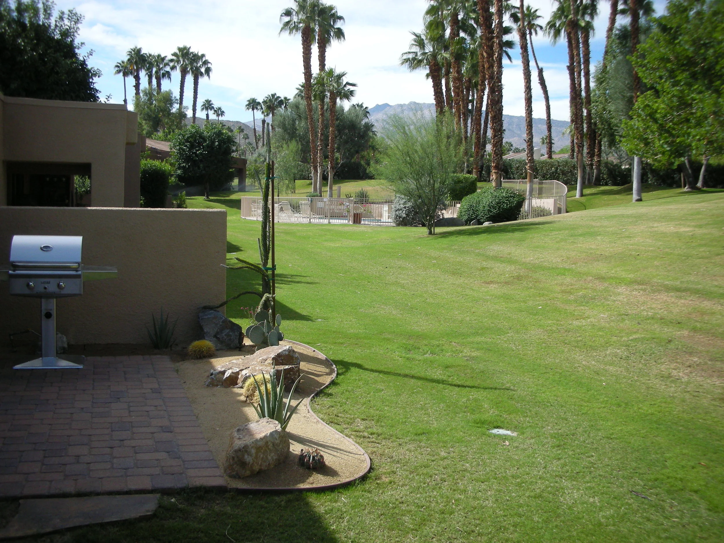 Rear yard greenspace with gas barbeque