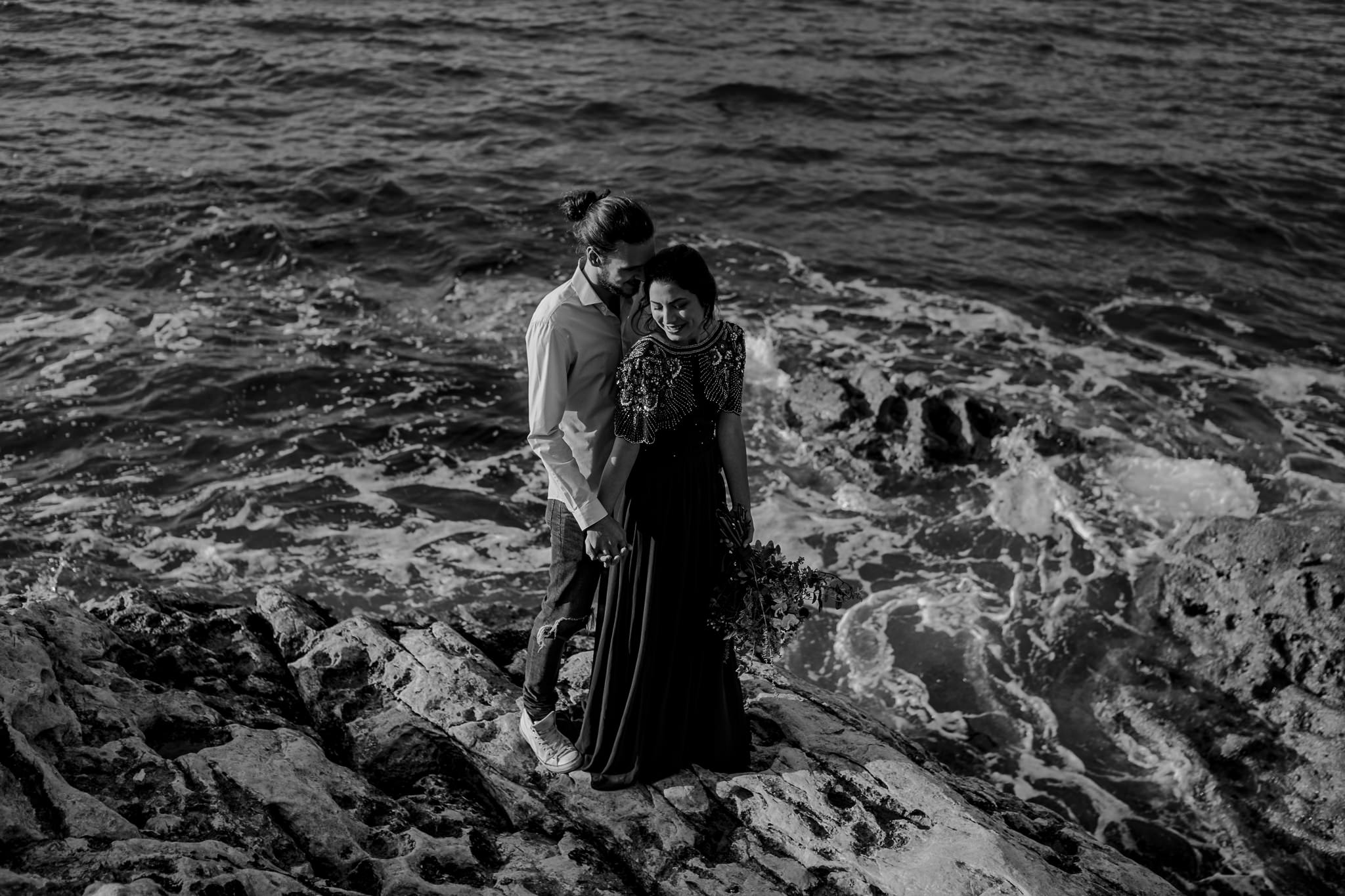  couple standing on the rocks on the North Coast during their pre wedding photoshoot 