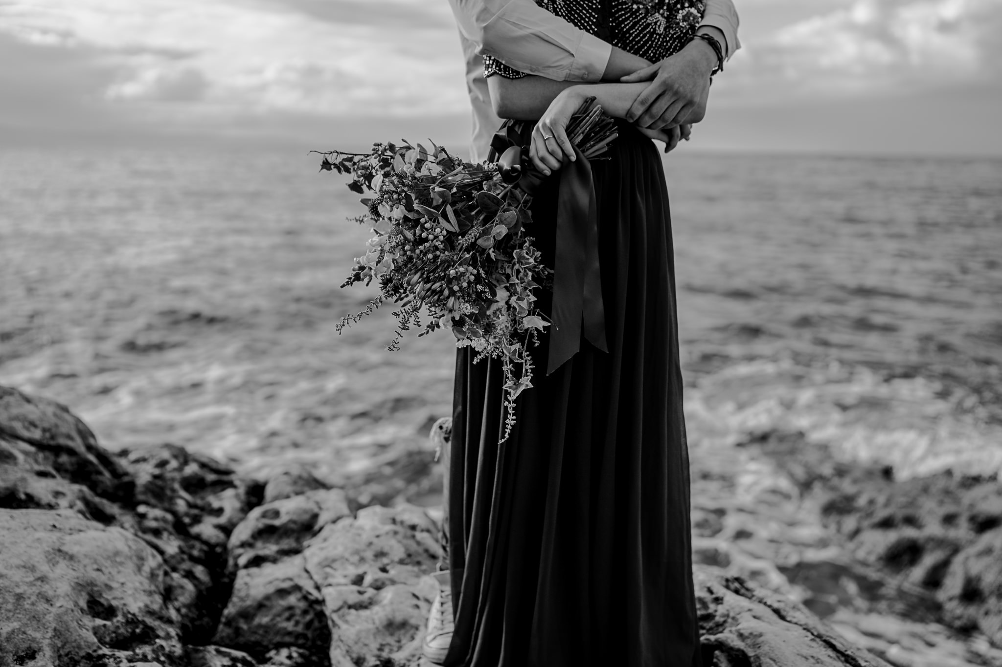  florist details bouquet couple hugging on the rocks of the North Coast Ireland 