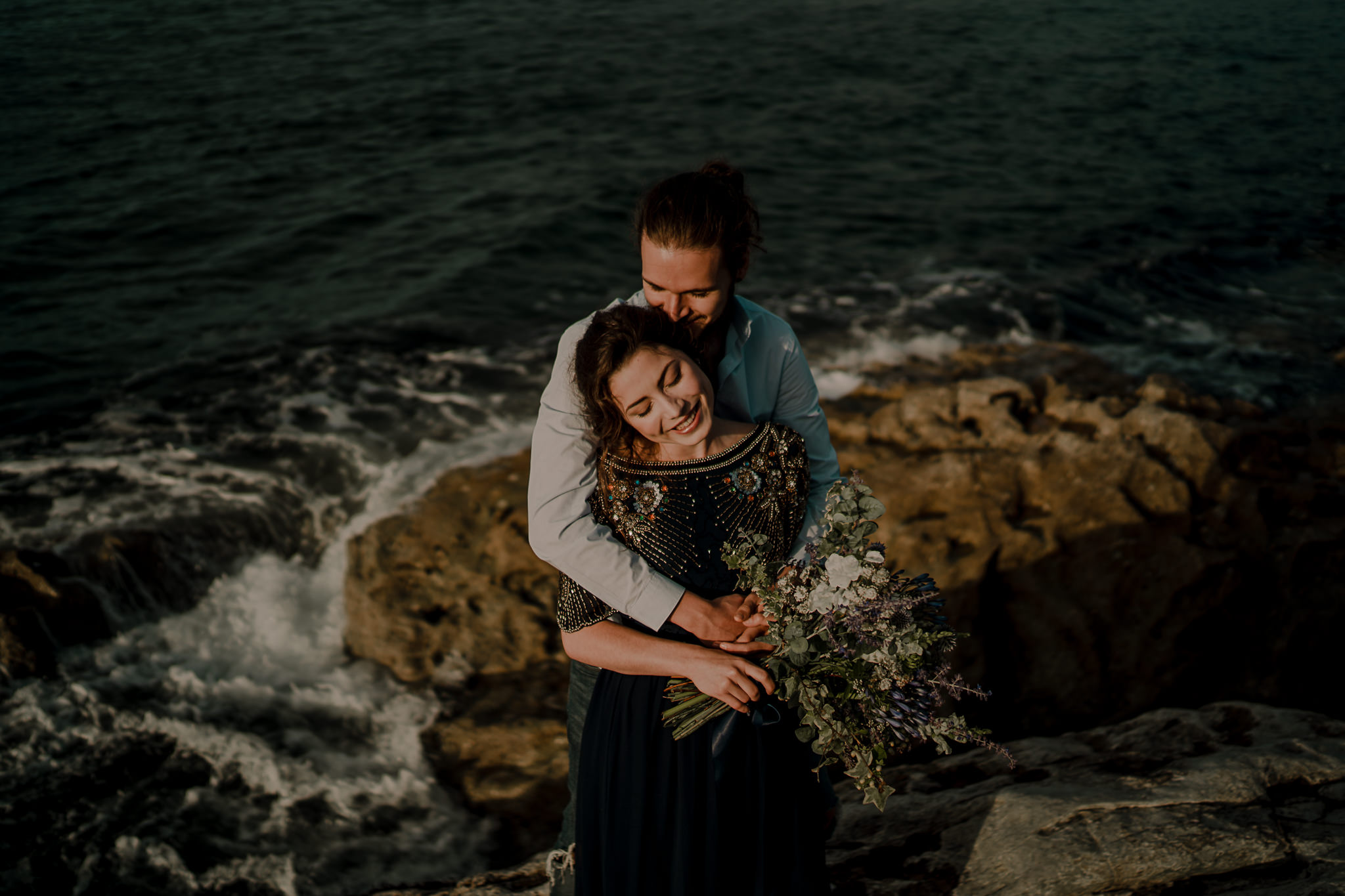 couple hugging during their pre wedding engagement photoshoot on the North Coast of Ireland