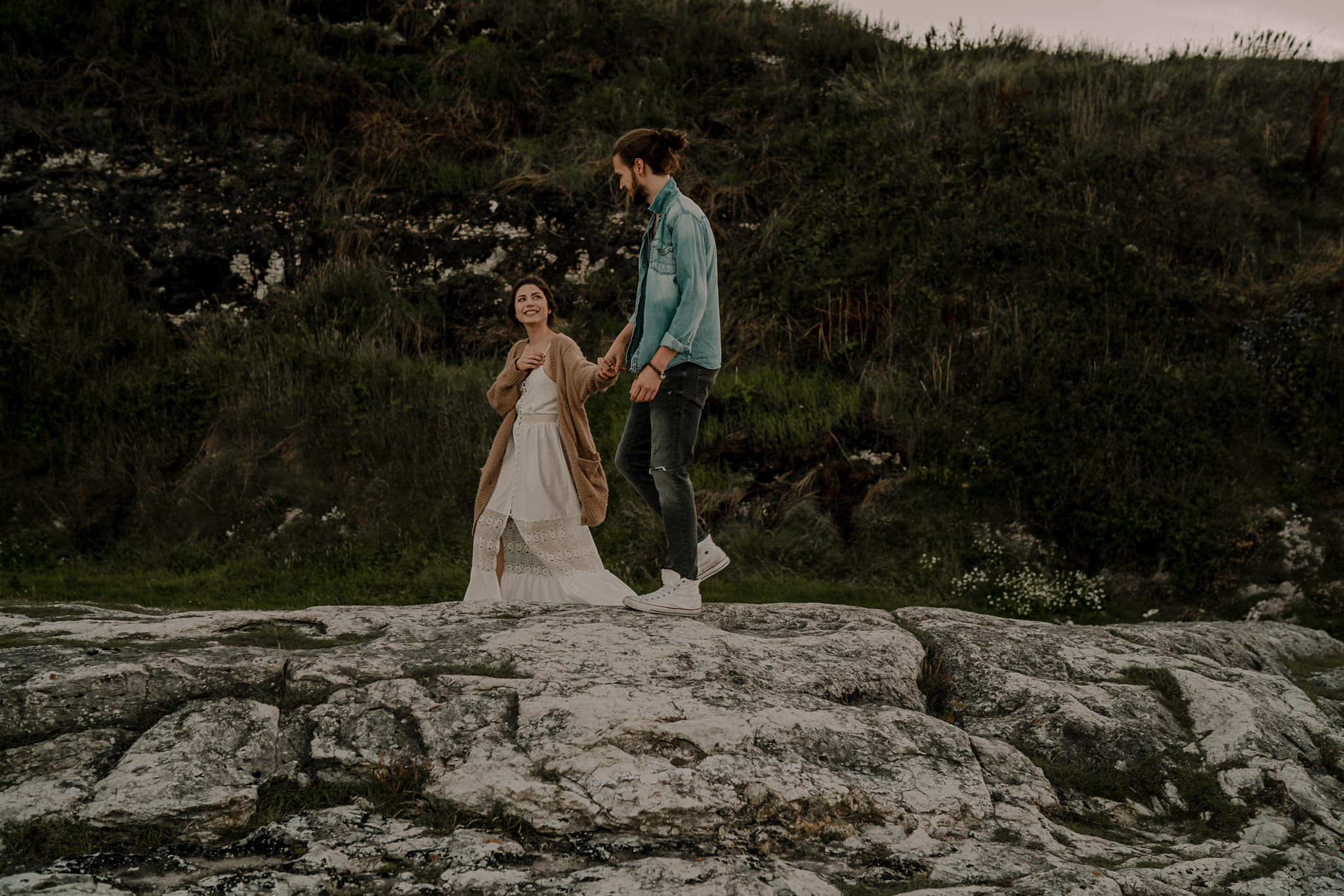  causeway coast hipster couple walking during their engagement photoshoot 