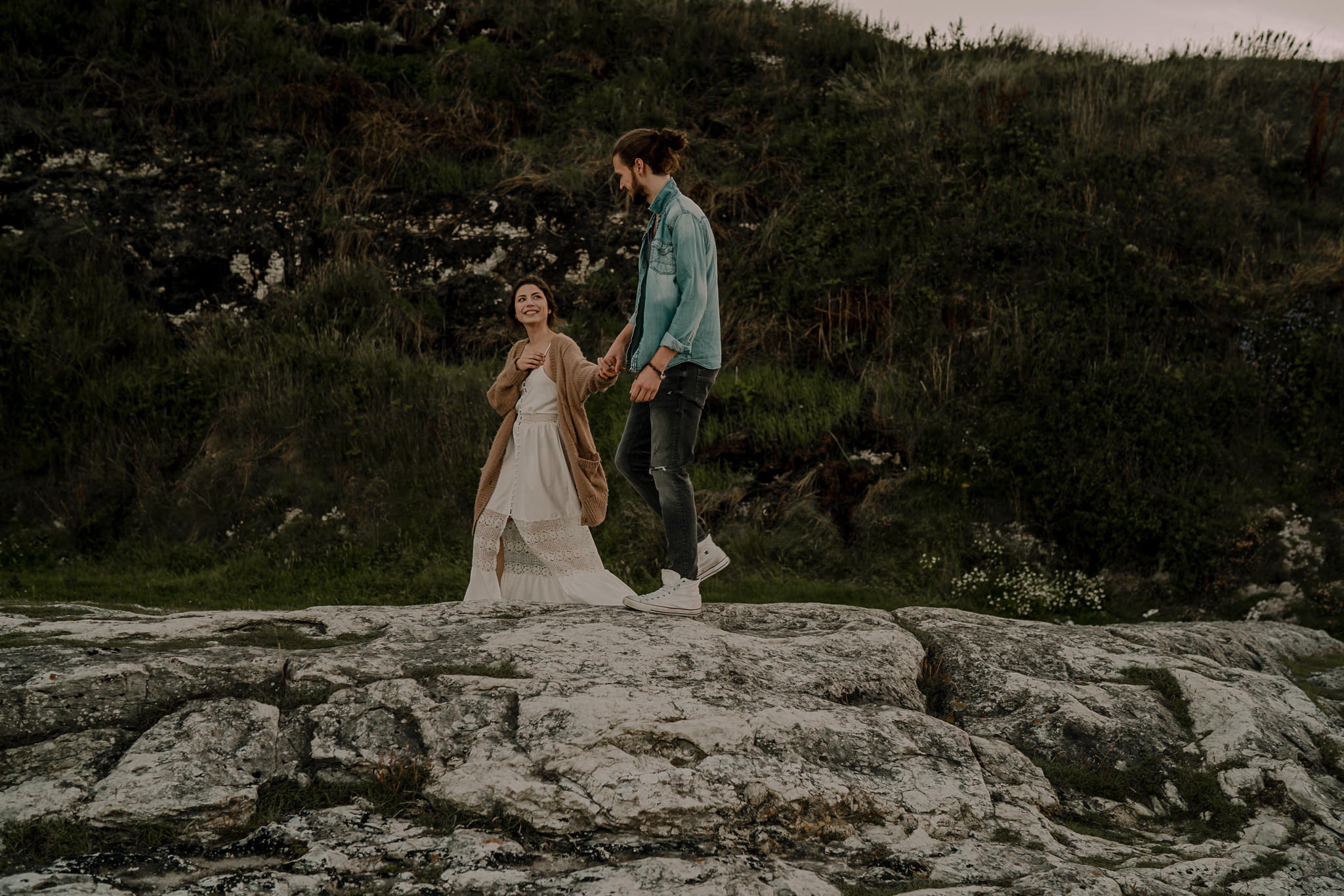 causeway coast hipster couple walking during their engagement photoshoot