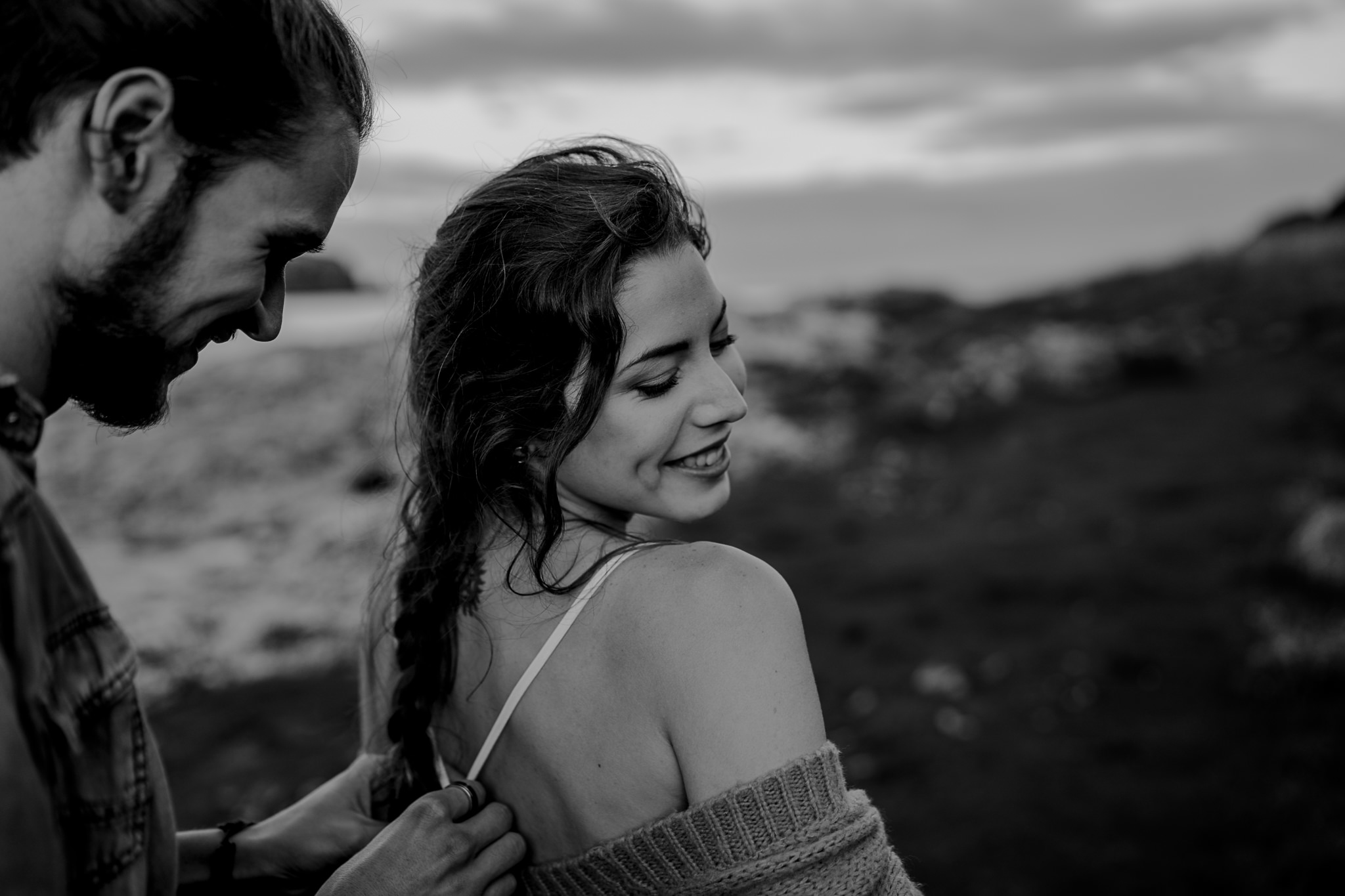 fixing her dress during an engagement session on the causeway coast