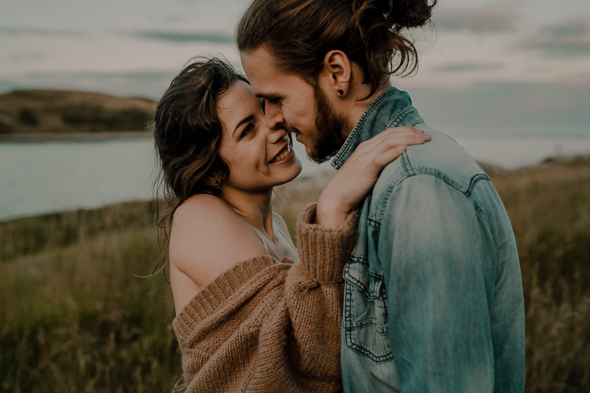 couple laughing and snuggling during their engagement photoshoot 