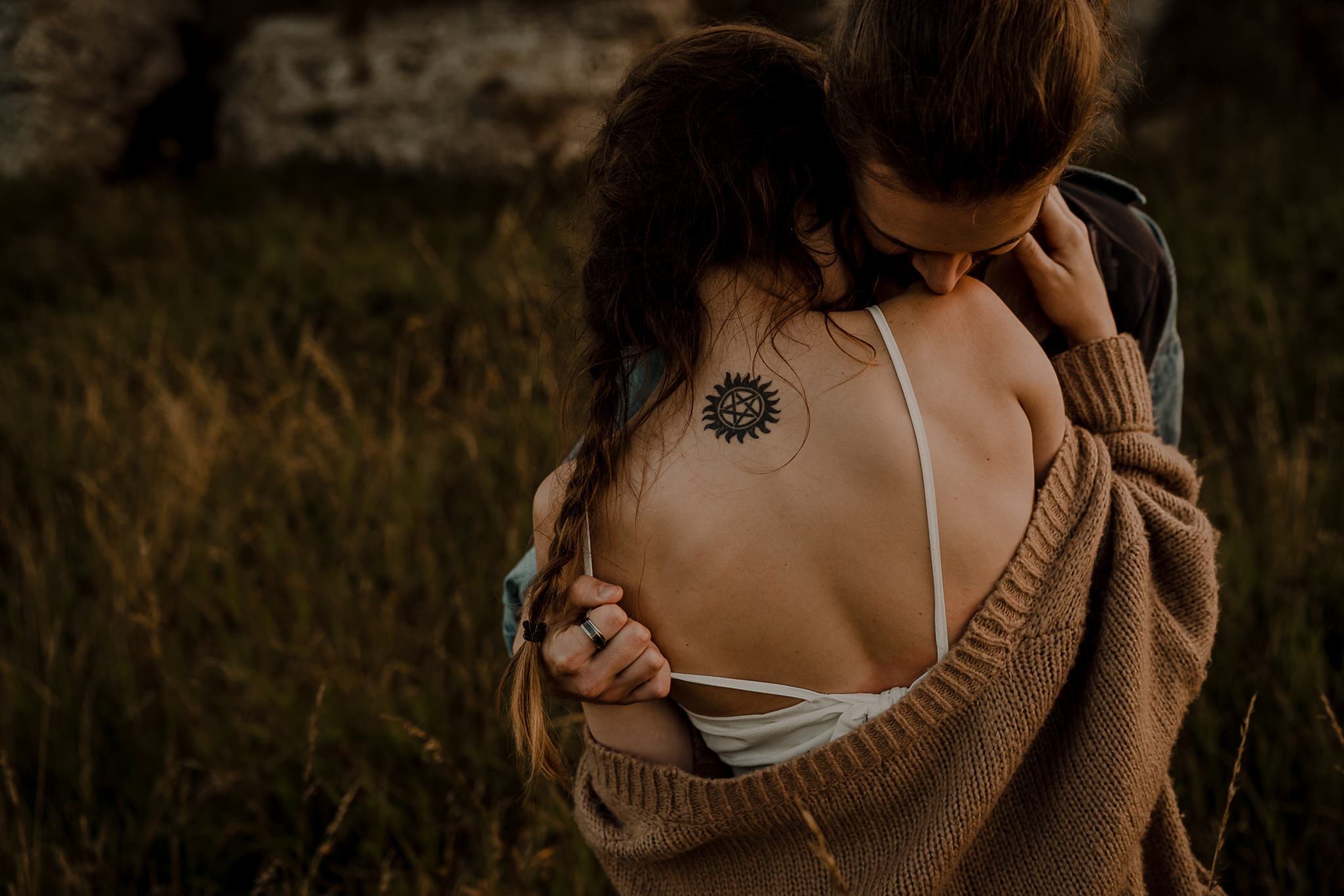 couple embrace on the irish coast during their engagement session