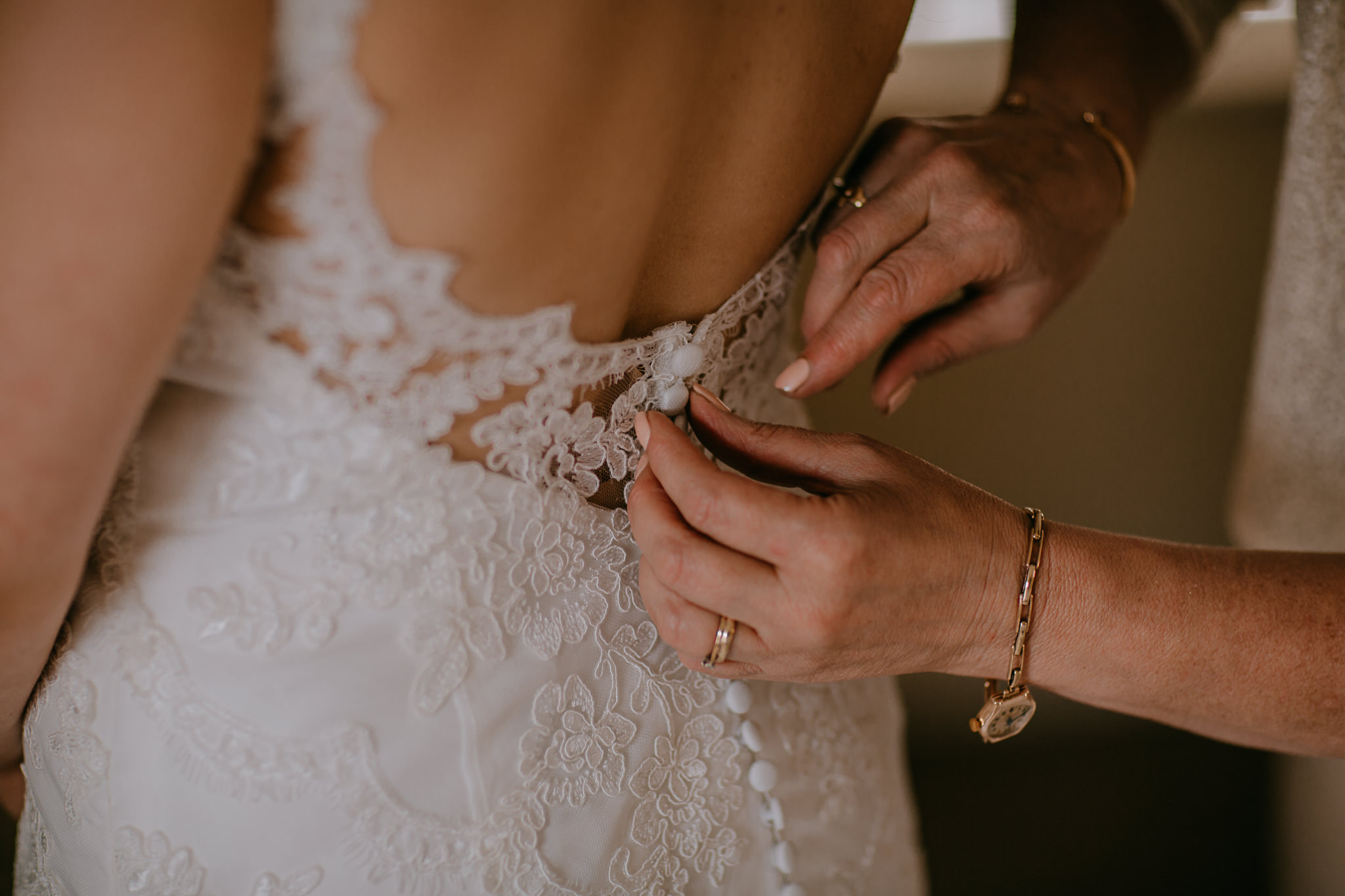  mother of bride buttoning wedding dress details Northern Ireland Wedding Photographers 