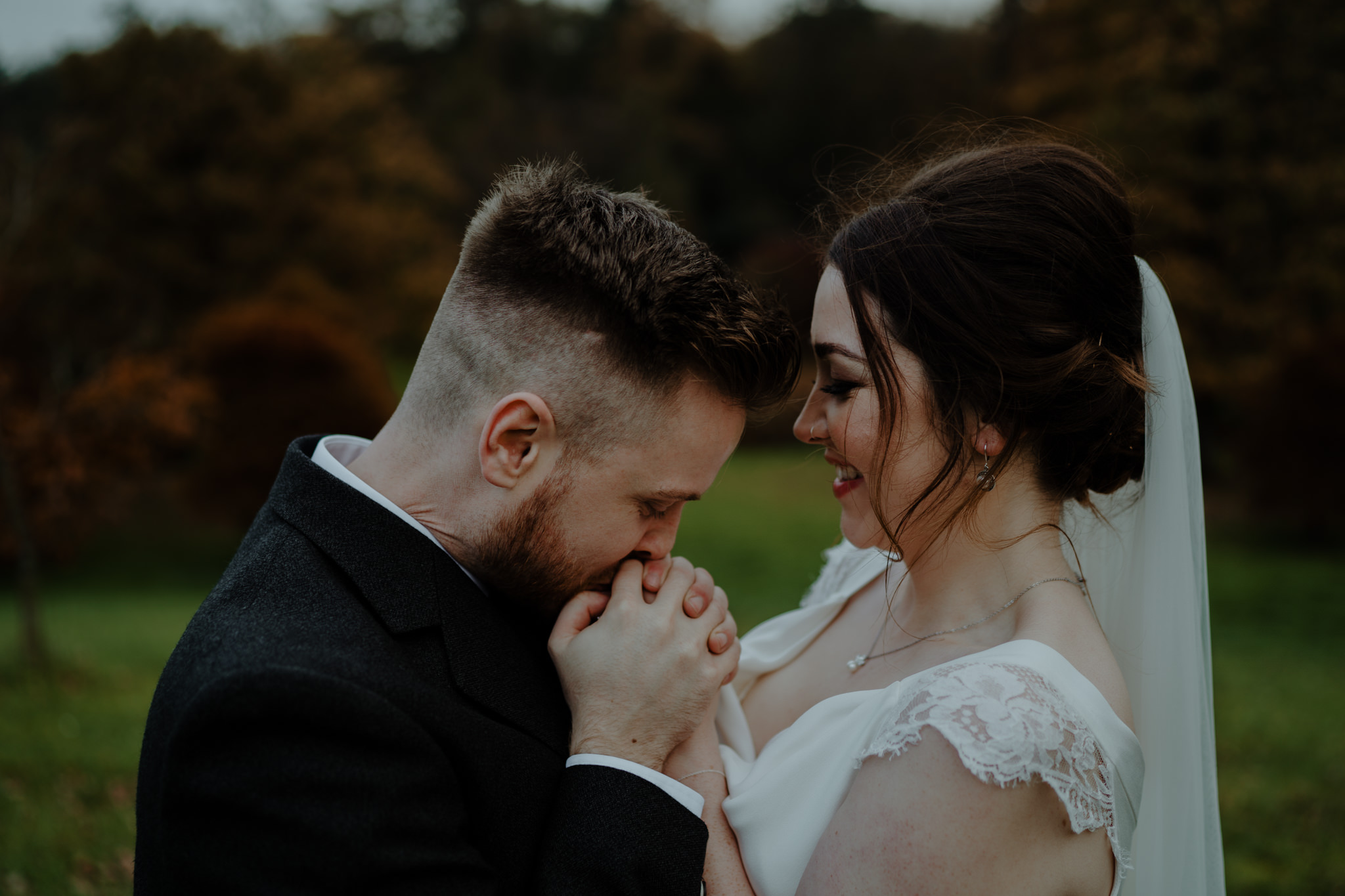 groom kissing brides hands wedding at lissanoure castle