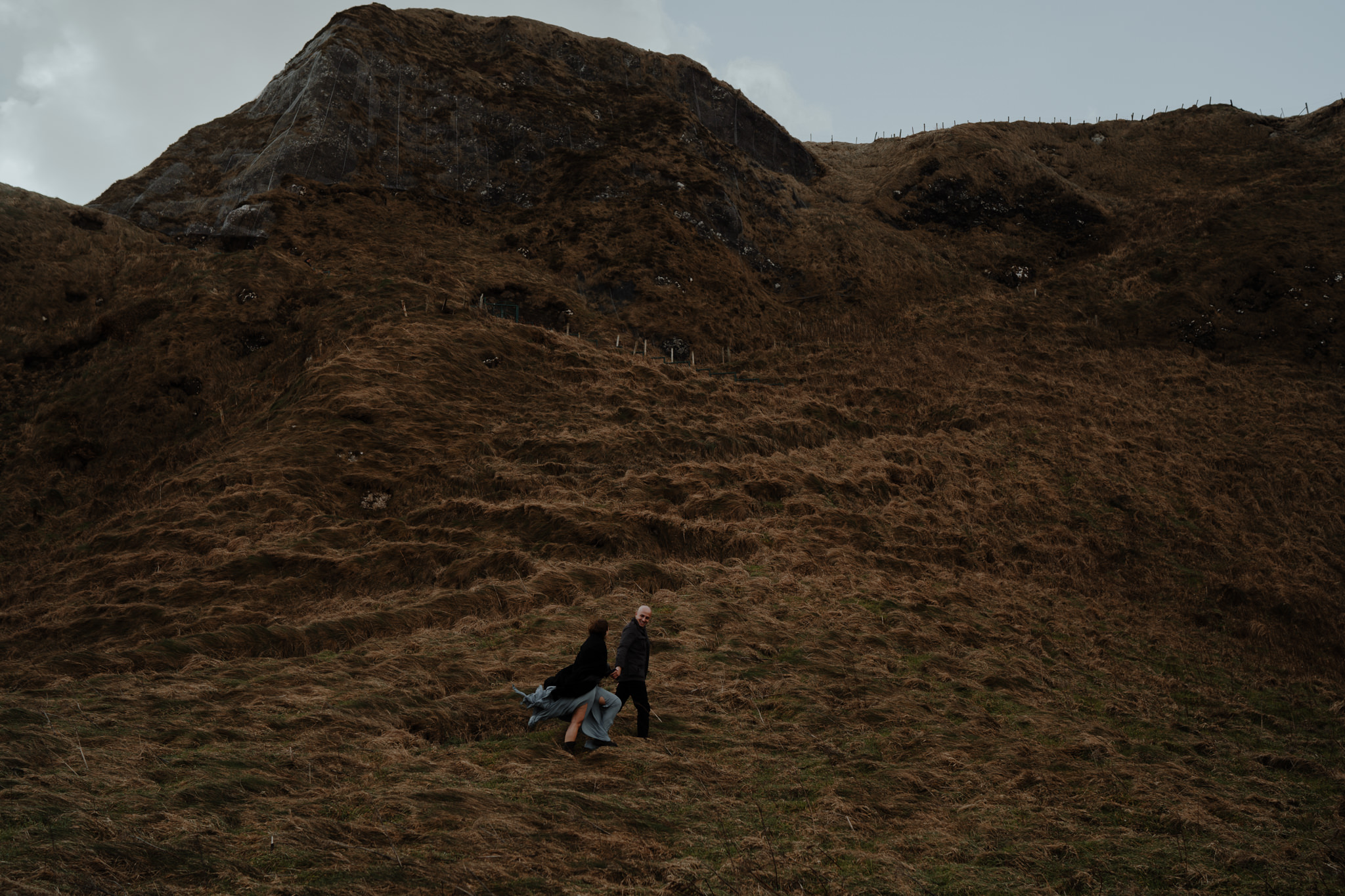 couple walking at kinbane castle