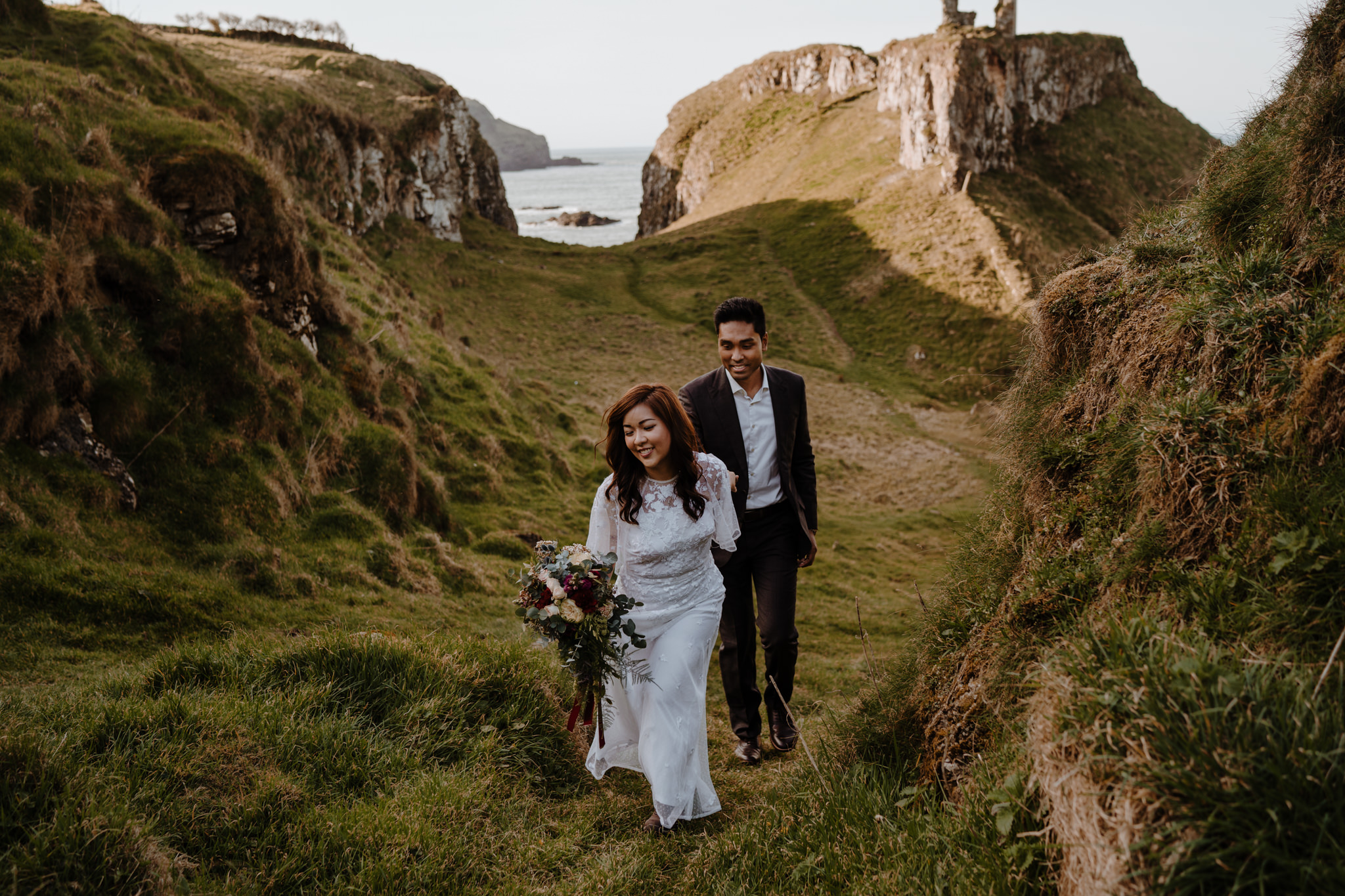 Adventurous Asian couple explore Dunseverick castle endgame to photography n.ireland