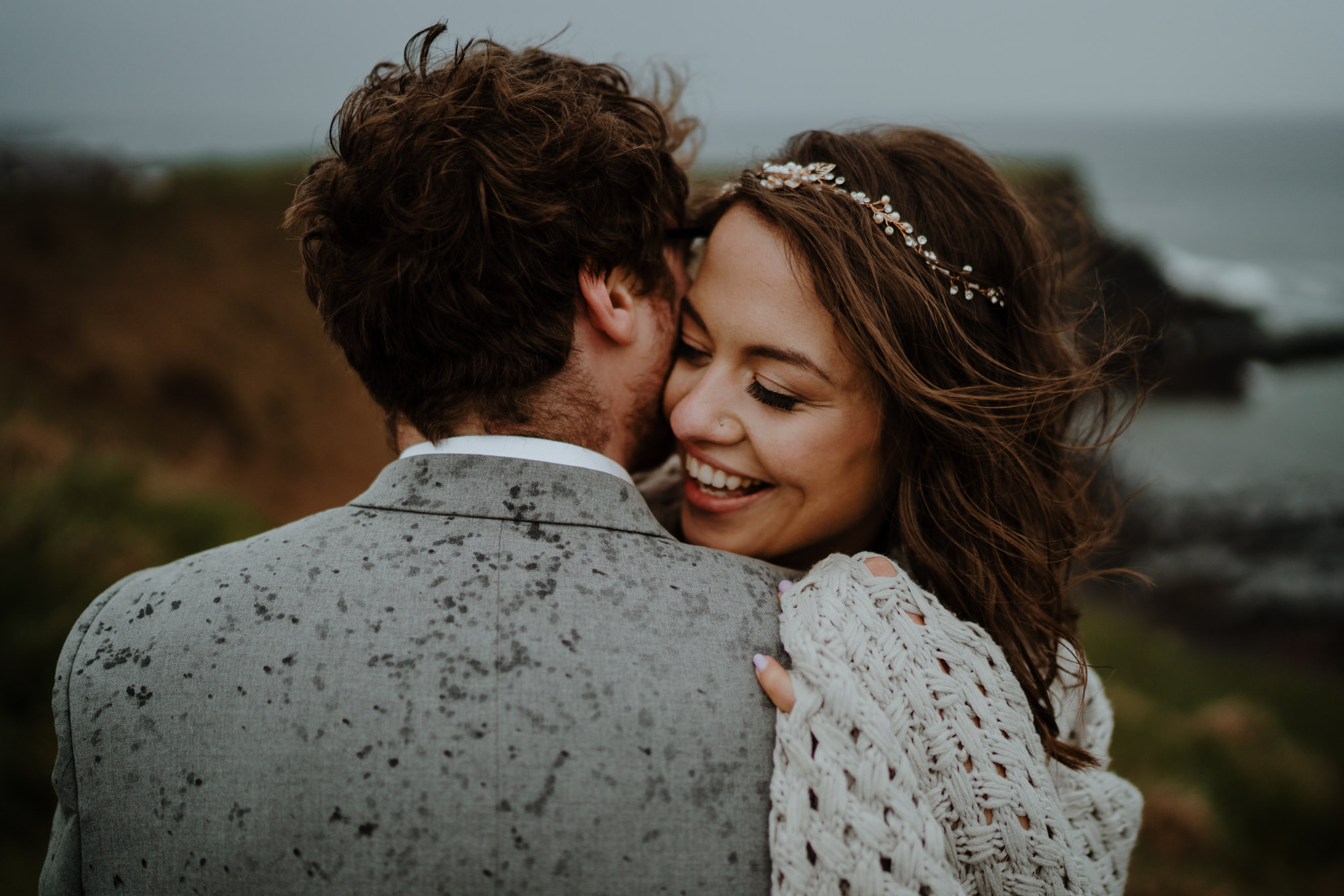 happy-couple-just-married-cliffs-dunluce-castle-elopement-photographers-Ireland