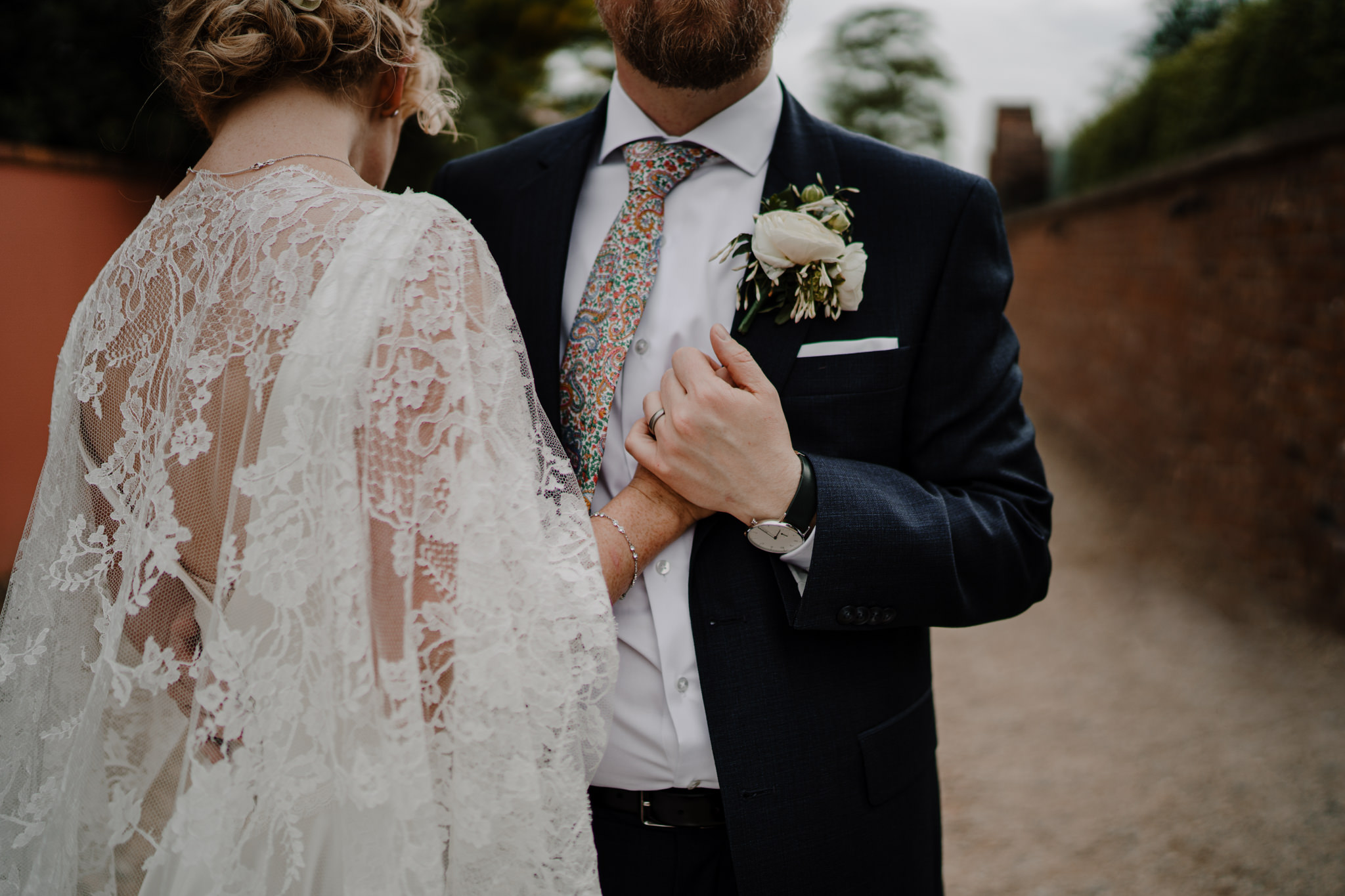 Tullyveery house wedding close up bride custome lace cape holding hands groom