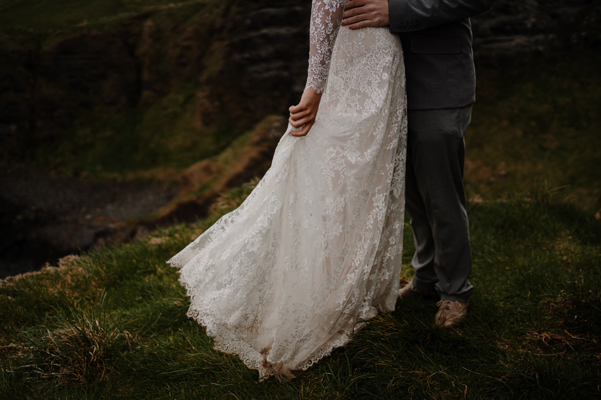 Vintage lace wedding dress cliff edge dunluce castle elopement