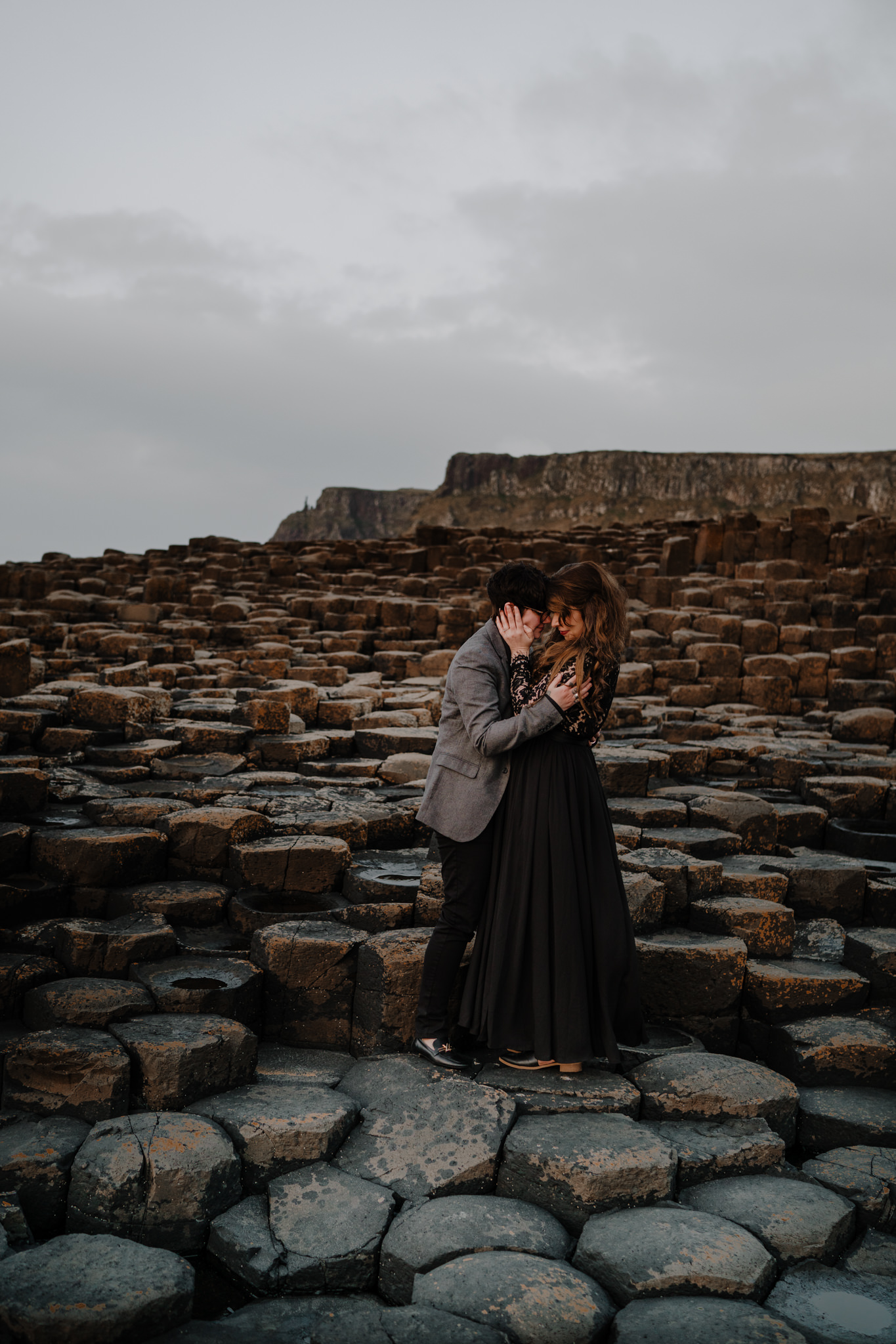 LGBTQ couple two girl embrace giants causeway sunset engagement photography