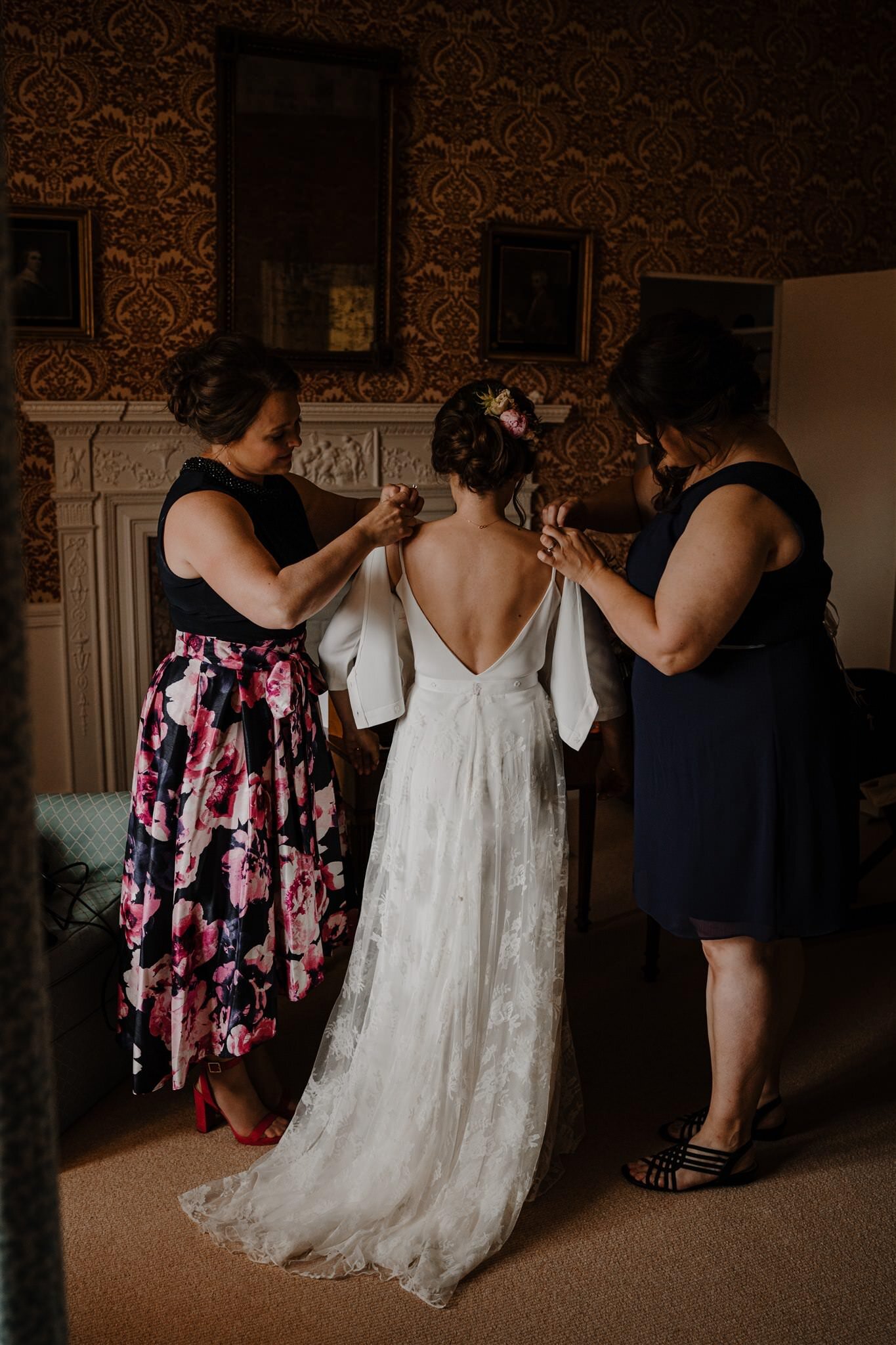 Bridesmaids help Bride get dressed in Charlie Brear wedding dress The West Wing Crom Castle