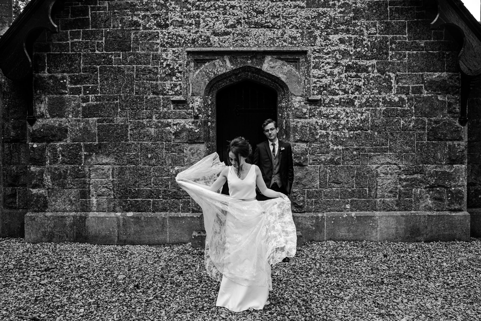 Alternative wedding photographers Ireland  bride swishes charlie brear wedding dress at west wing crom castle boat house
