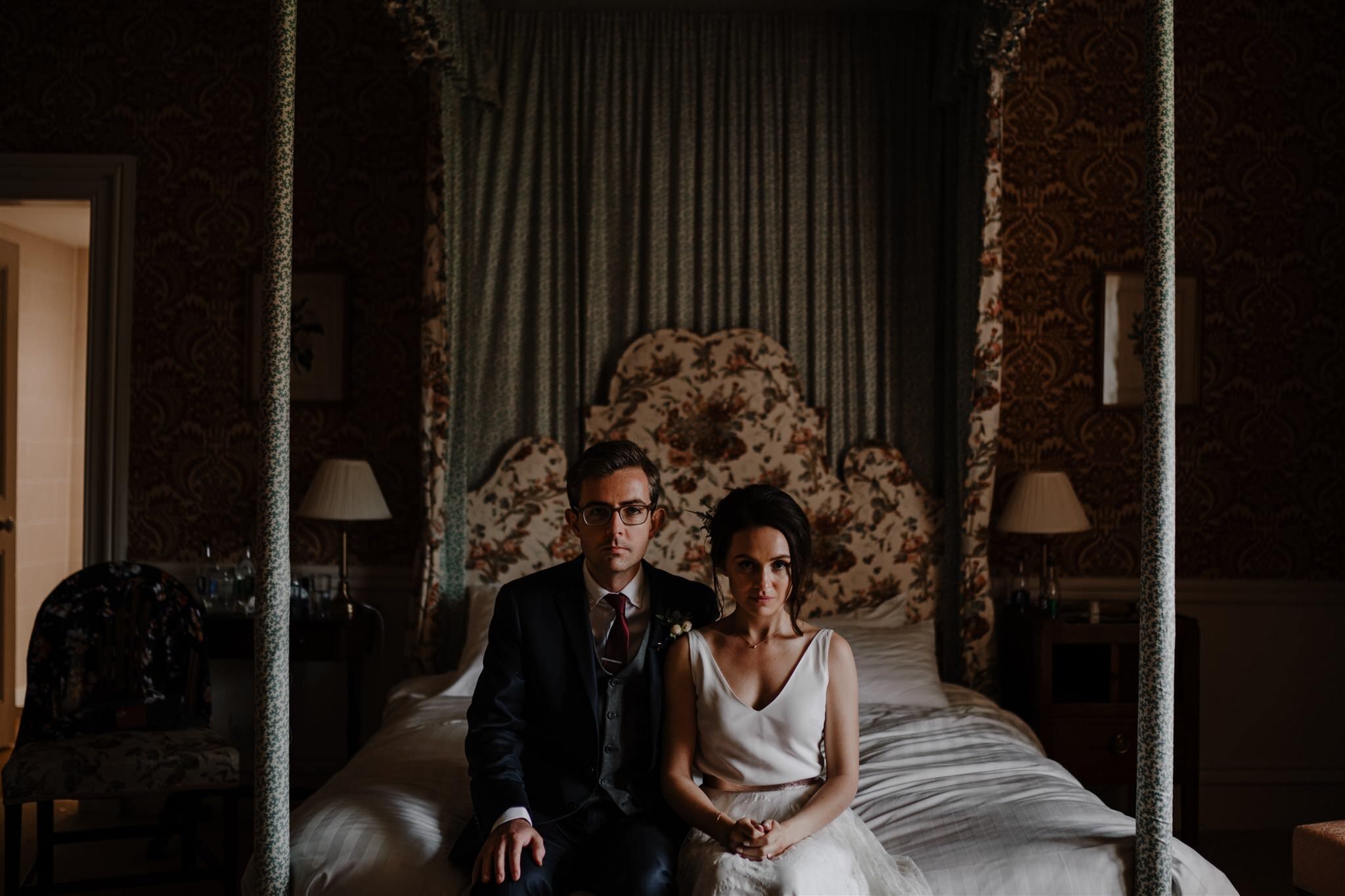 Wes Anderson style wedding portrait bride groom on bed West wing Crom Castle intimate alternative wedding photographers Ireland