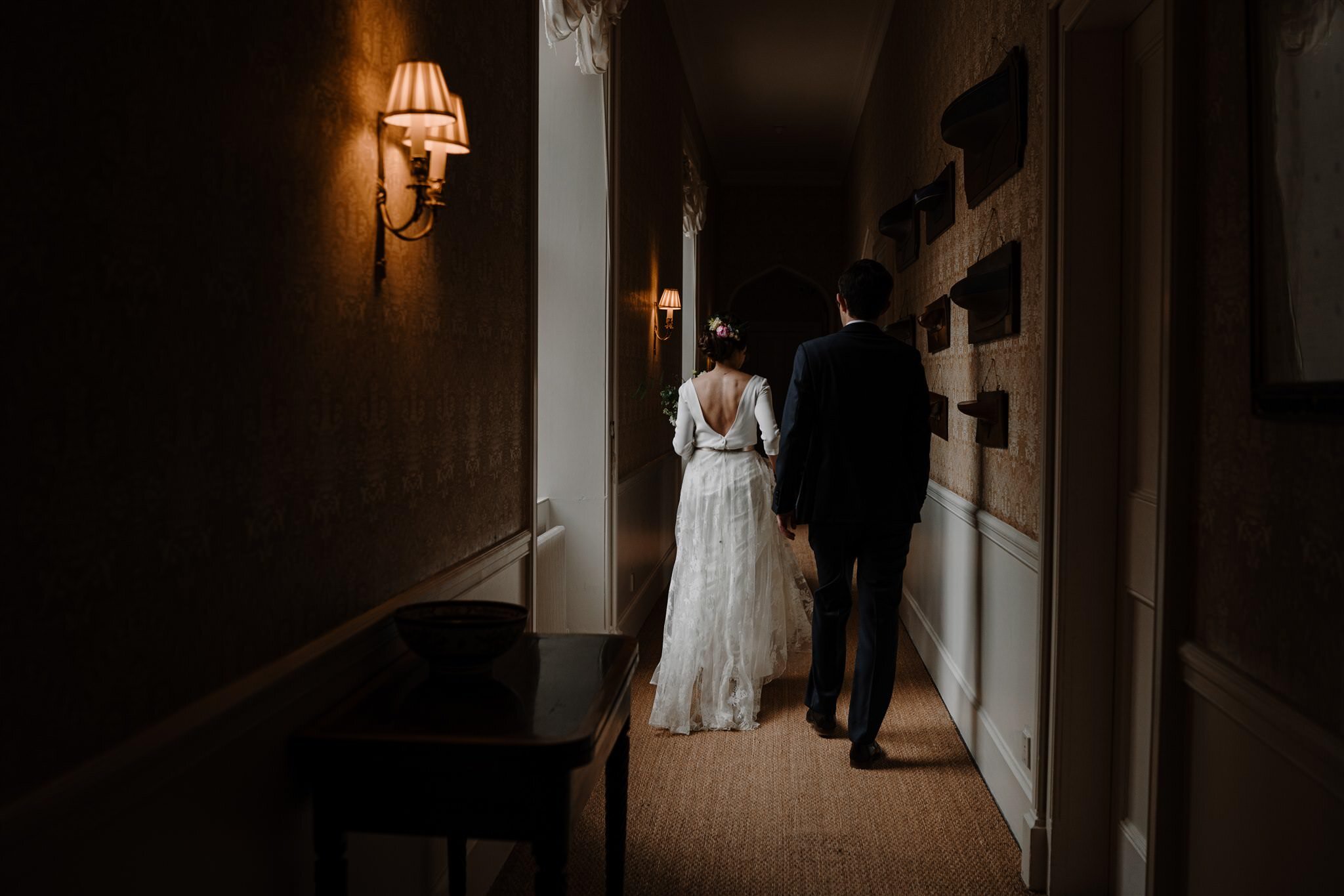 bride and groom walk halls at The west wing Crom Castle