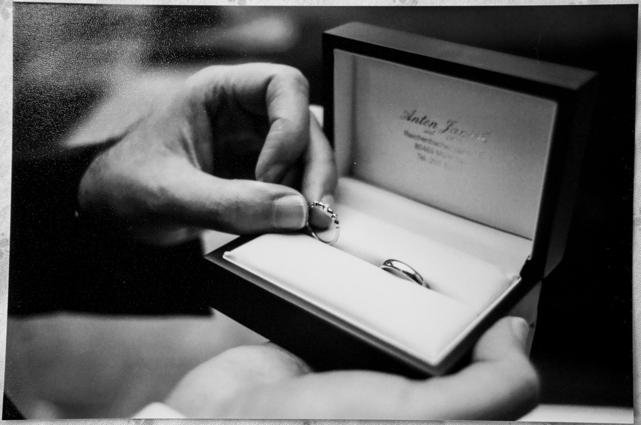 bw film photo groom holding rings Crom Castle Wedding