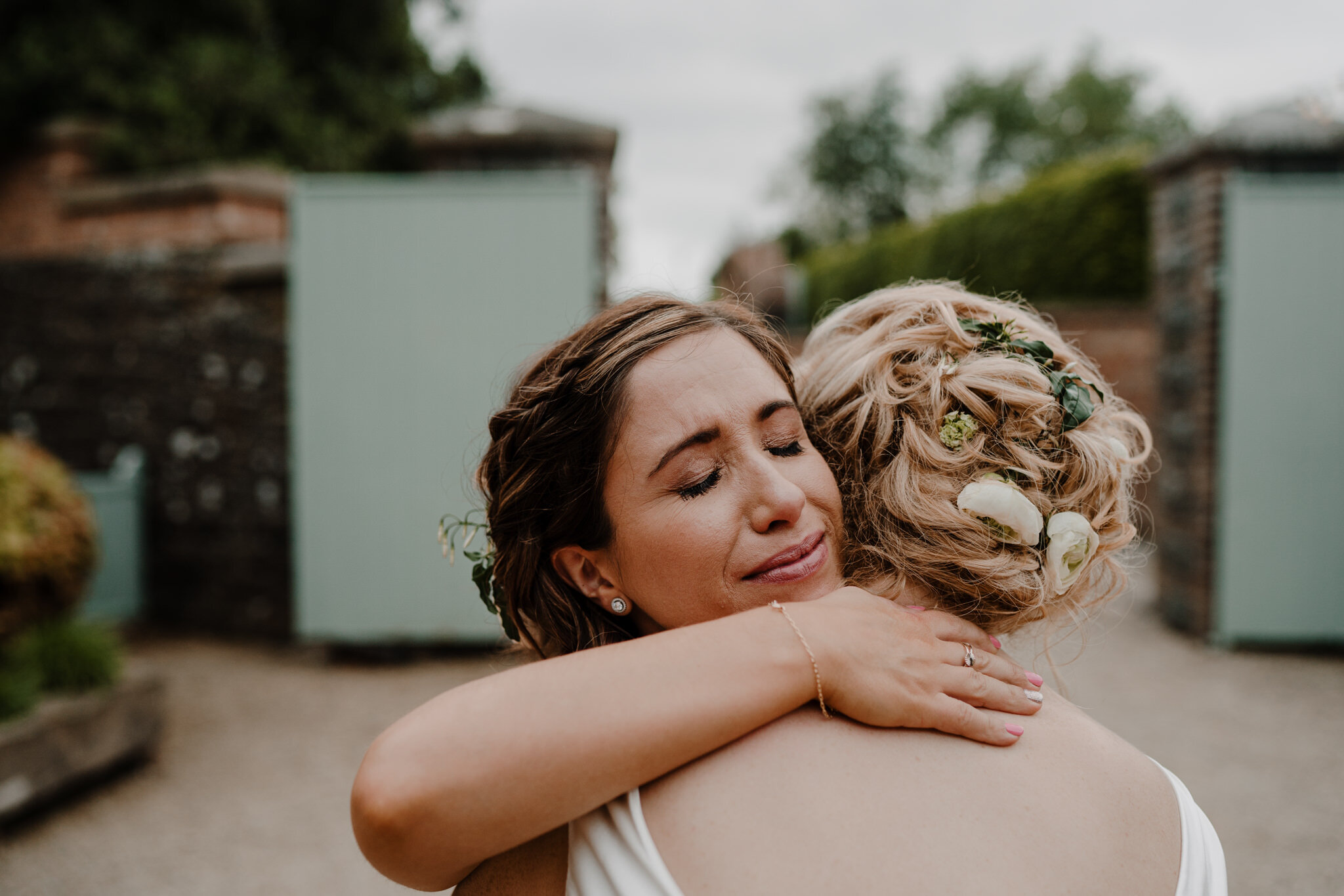 bride-bridesmaid-hugs-emotional-wedding-photography-tullyveery-house