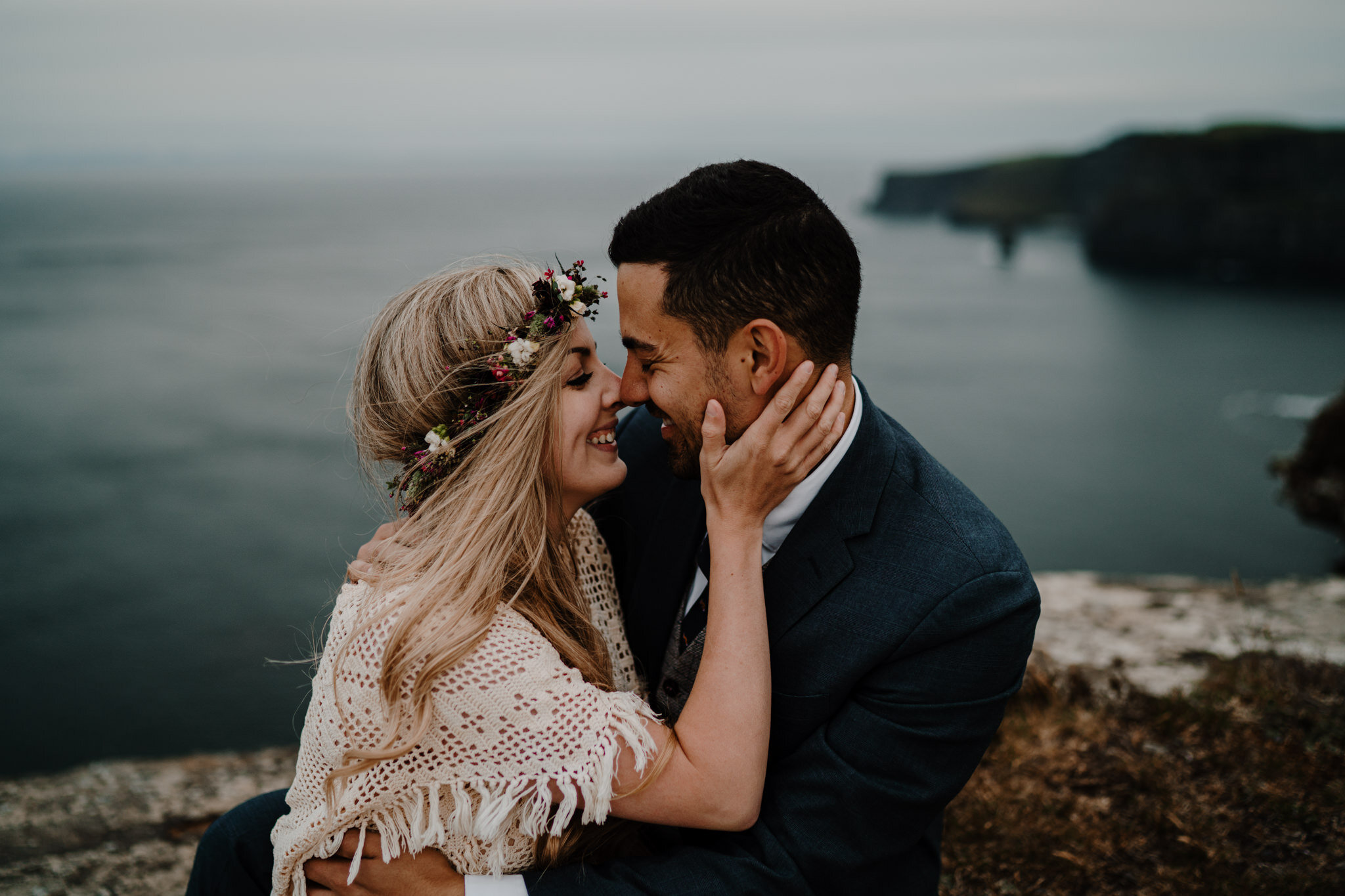 boho couple embrace and kiss cliffs edge anniversary session Cliffs of Moher ireland