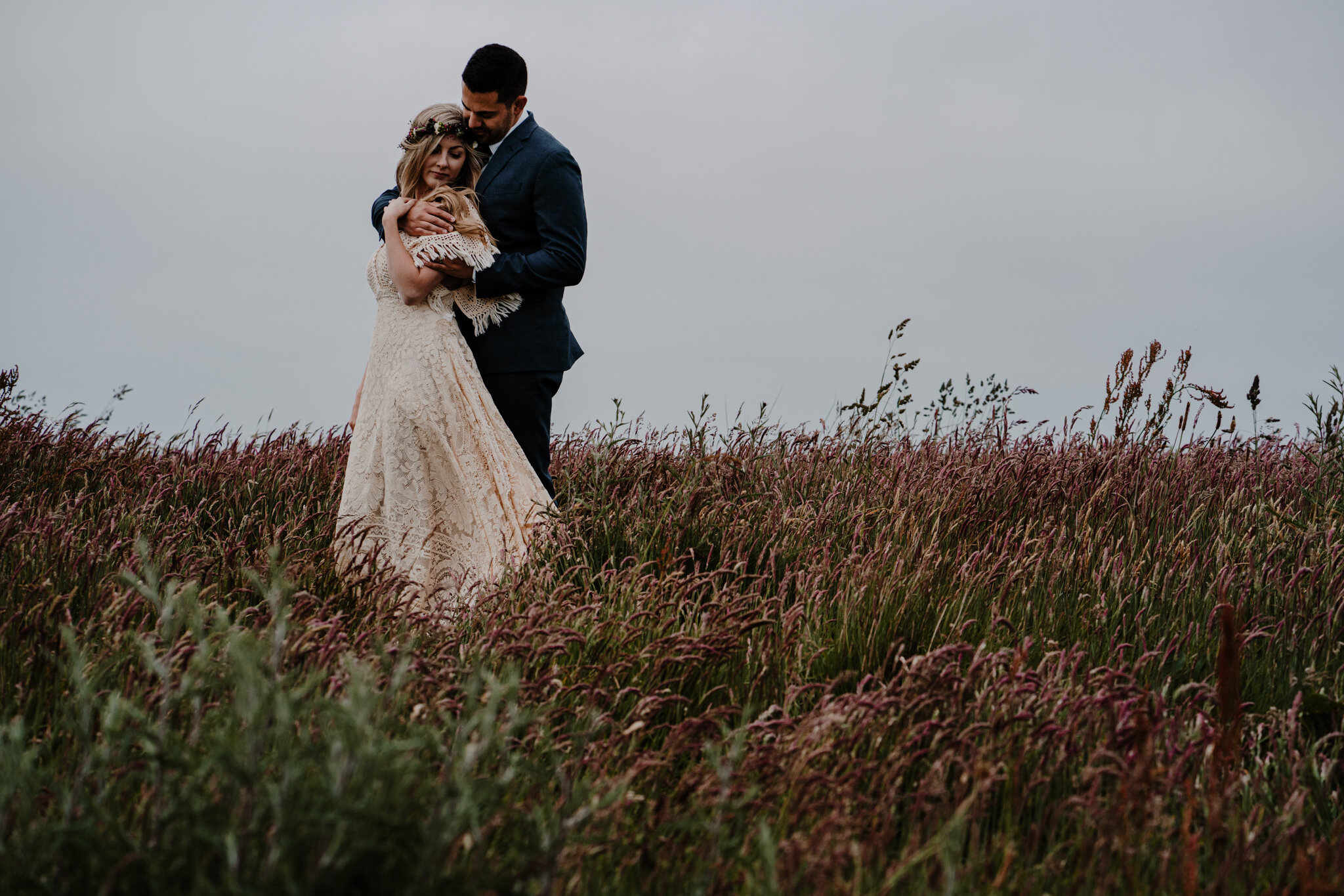 boho free spirited couple embrace in field Cliffs of Moher ireland