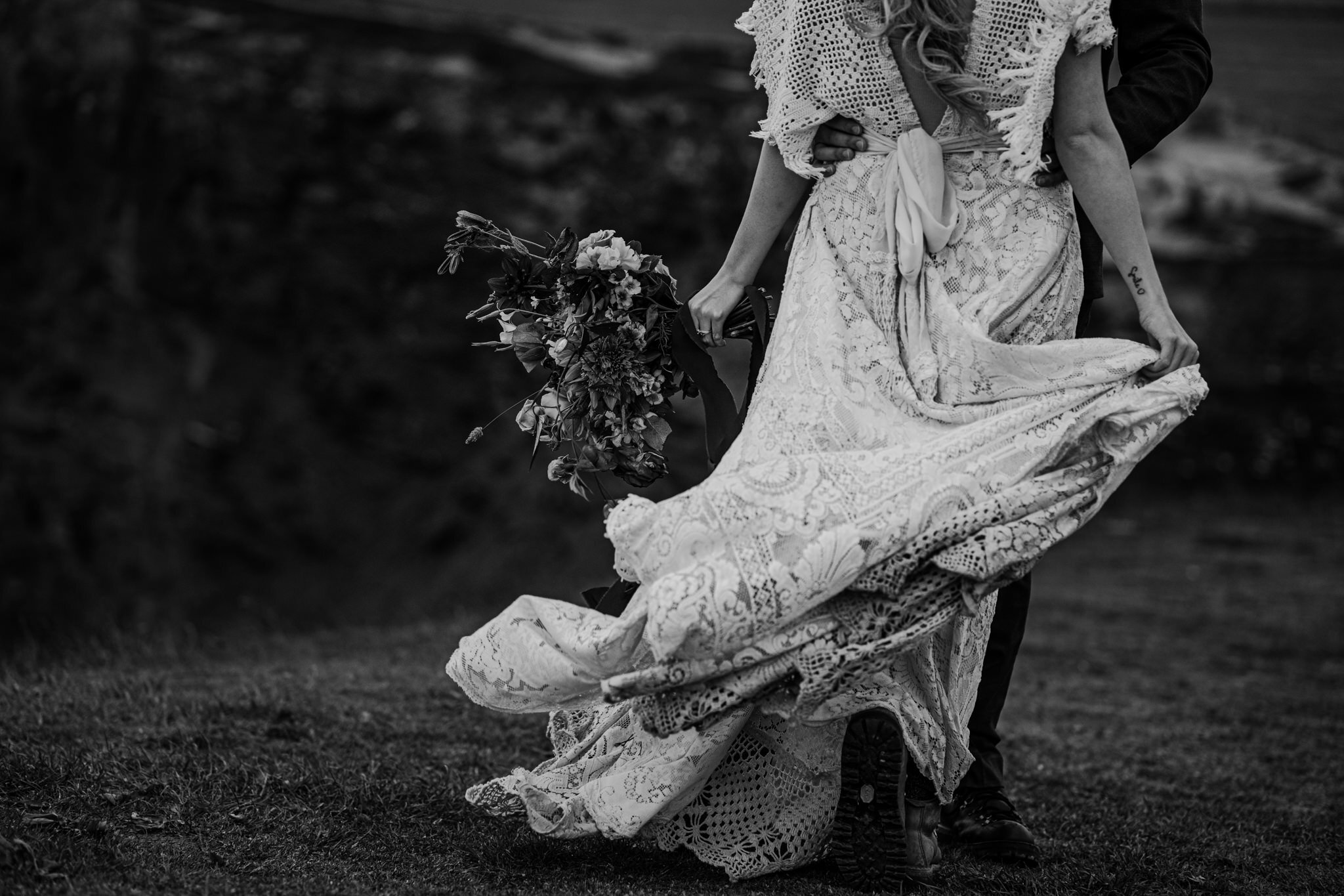 bw custom crochet reclamation wedding dress flows in wind cliffs of Moher adventure elopement photographers