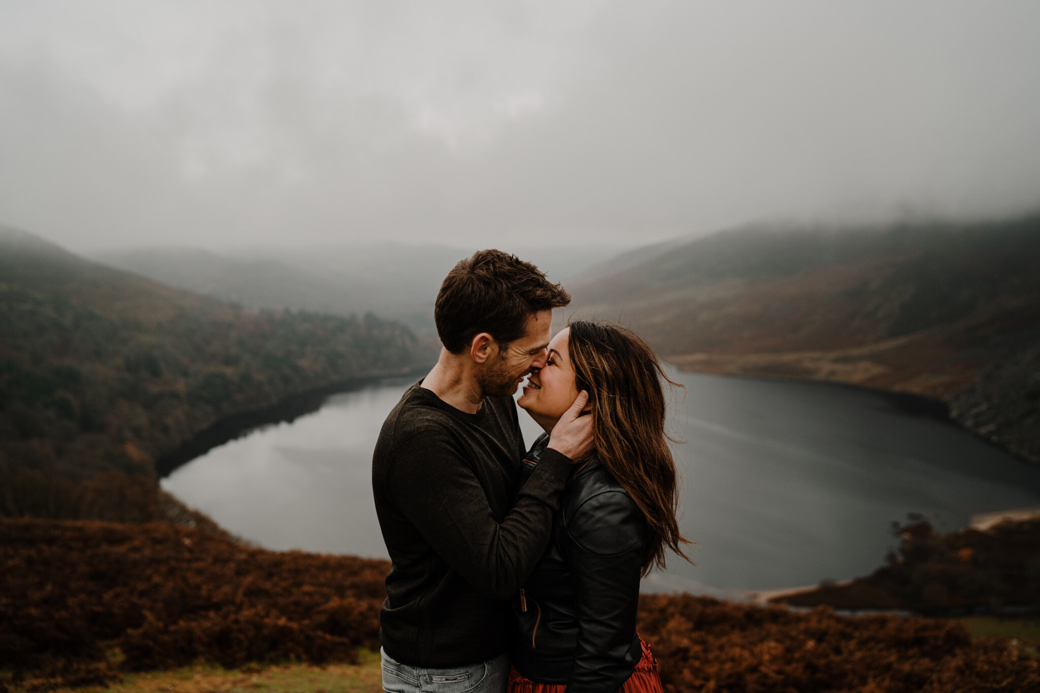 couple embrace smiling in the misty fog at Wicklow Mountains ireland